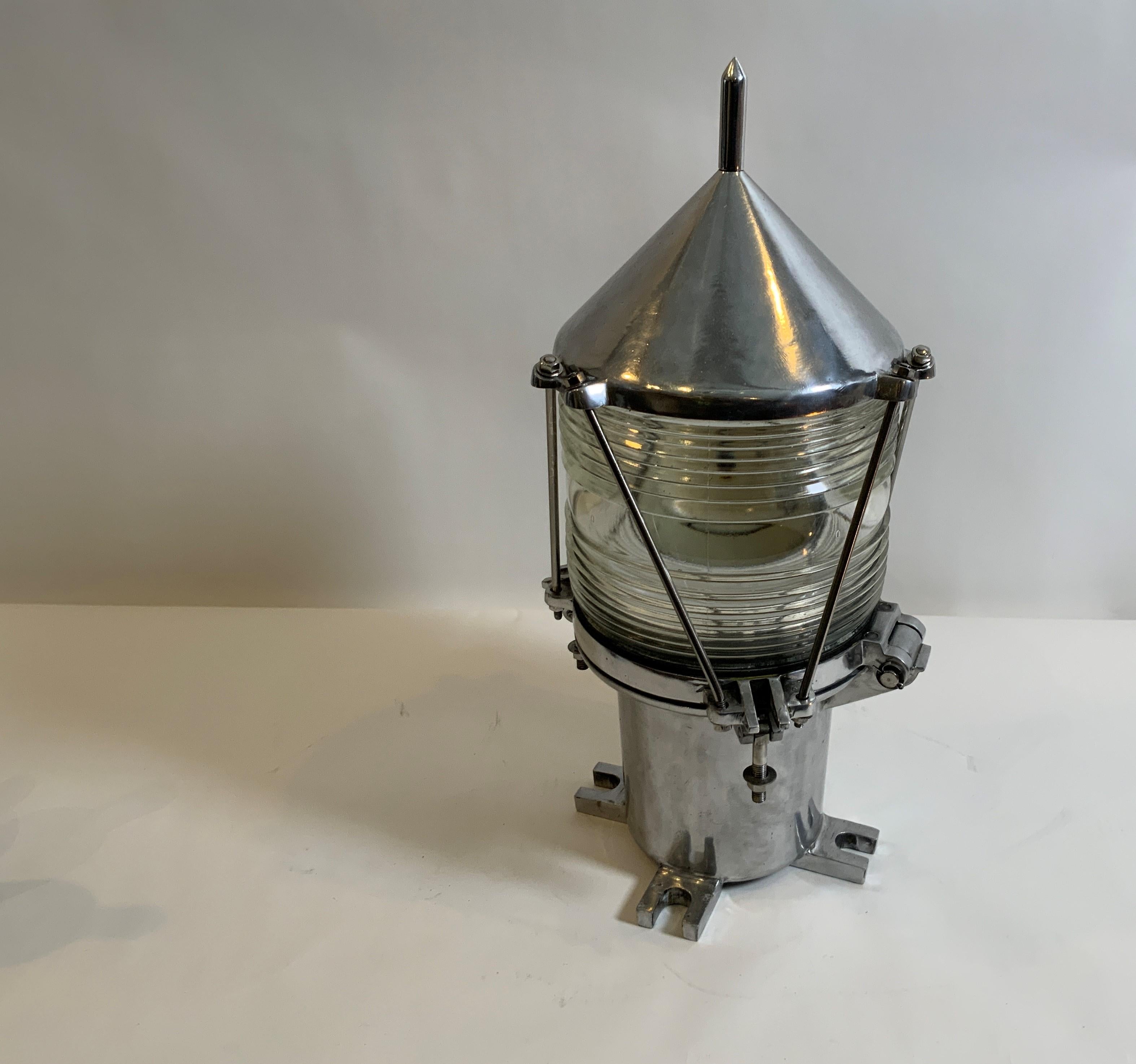 Highly polished marine beacon with Fresnel lens. Fitted with protective bars, four flange feet and spiked top. Marked BU-16 and U.S.C.G. Converted to electricity. Circa 1950.

Overall dimensions: 23