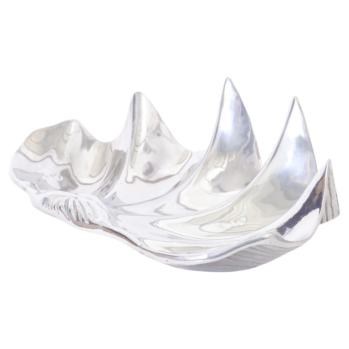 Mid century bowl crafted in cast and polished aluminum in the iconic clam shell form. Signed in the cast on the bottom.