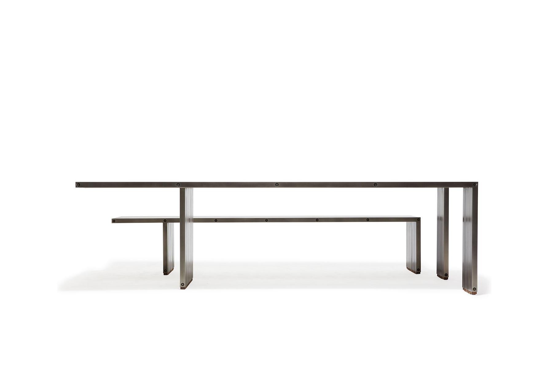 The compression table by Stephen Kenn is a celebration of simplicity and strength. The bars are held together without nails or welds, but through compression along steel rods. The Compression Table can be paired with the matching Compression Bench