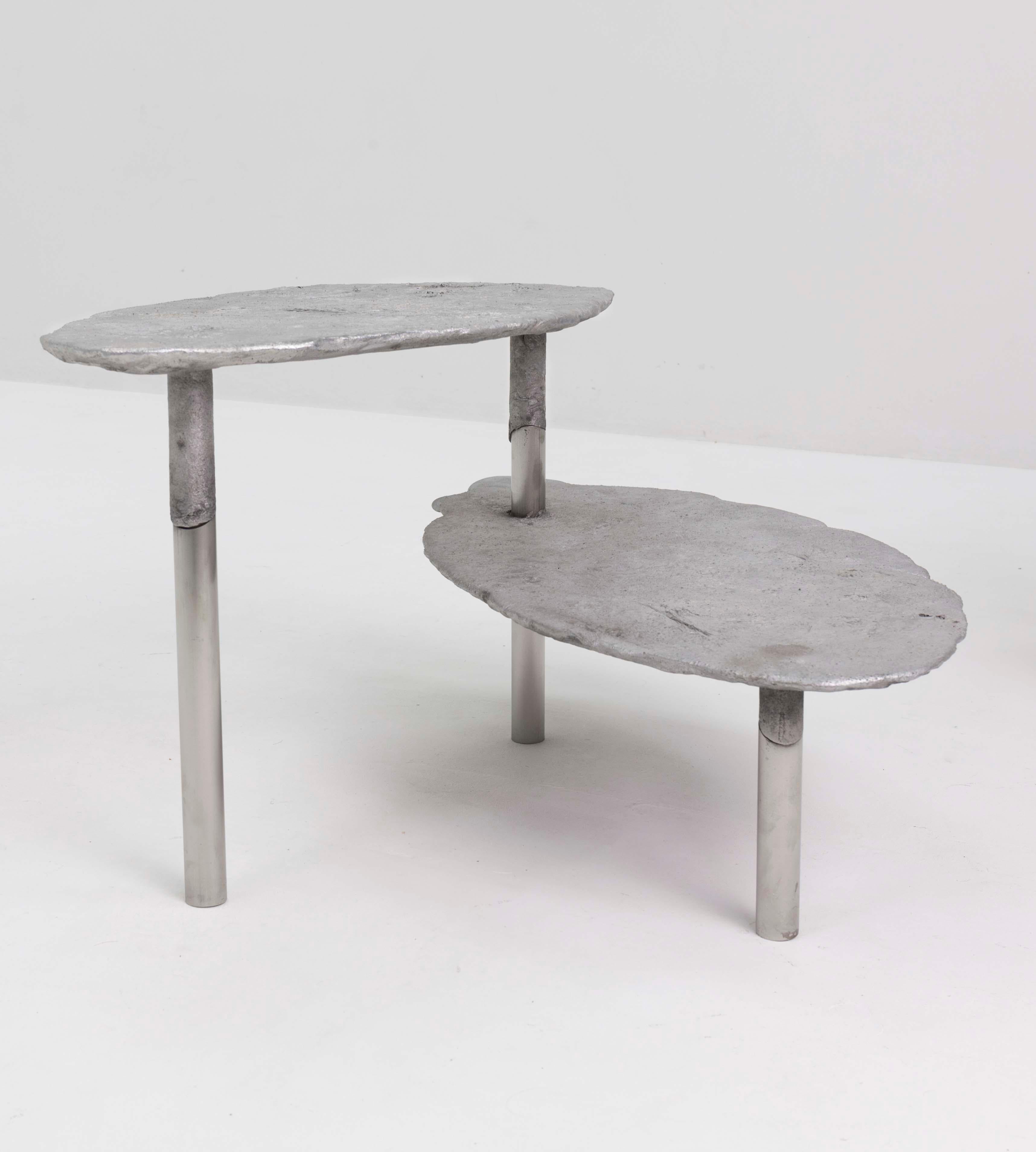 Aluminum concretion coffee table by Studio Julien Manaira
Dimensions: 65 x 65 x 40 cm
Materials: Aluminium and stainless steel

The concretion project consists of sand-casting aluminium in a base of stainless steel tubes to form objects. The