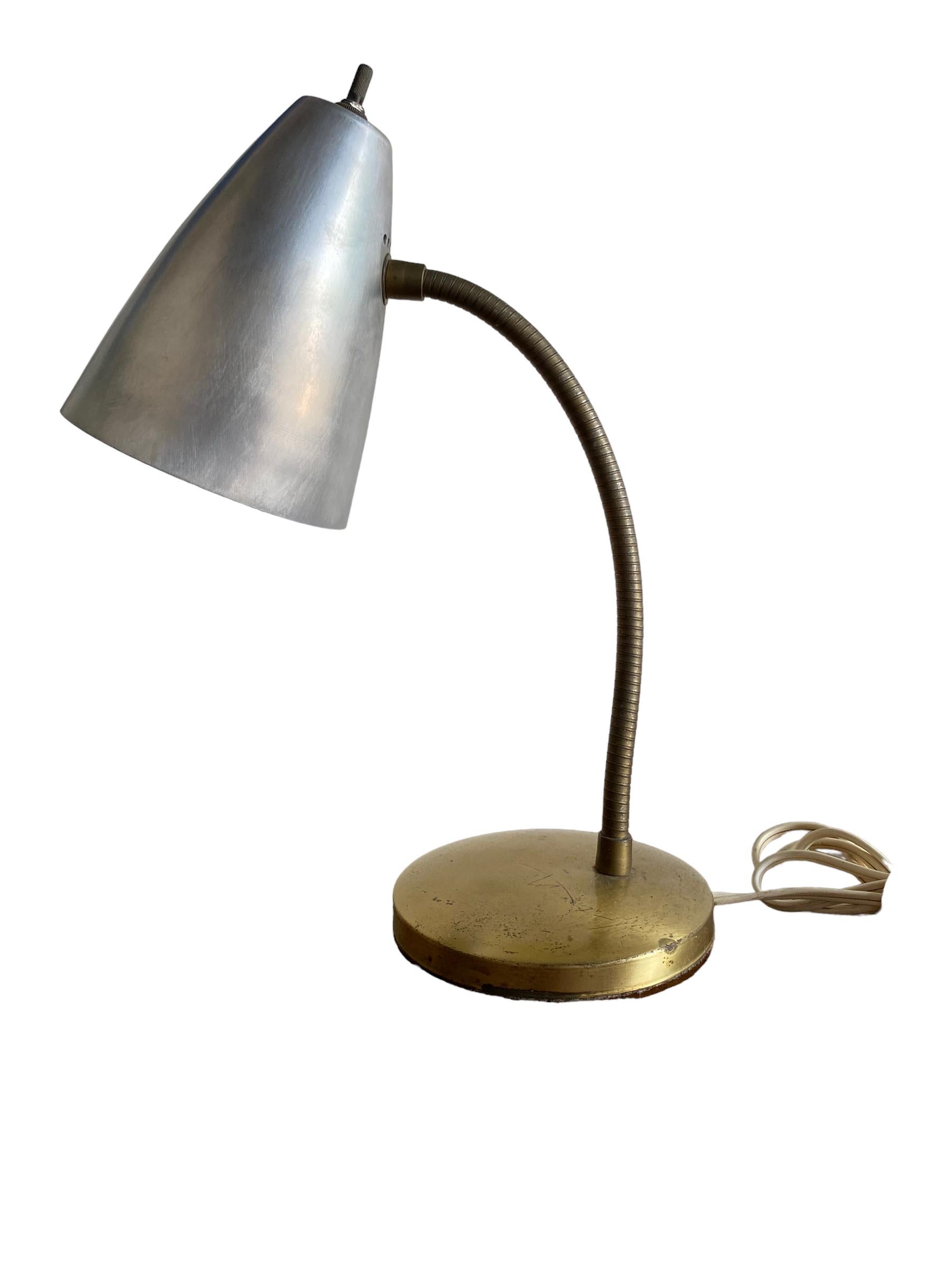 Excellent gooseneck desk lamp with aluminum shade and brass gooseneck and base. Period mid century. Rotary style switch controls the light. Gooseneck function allows for the lamp to pivot in any direction.