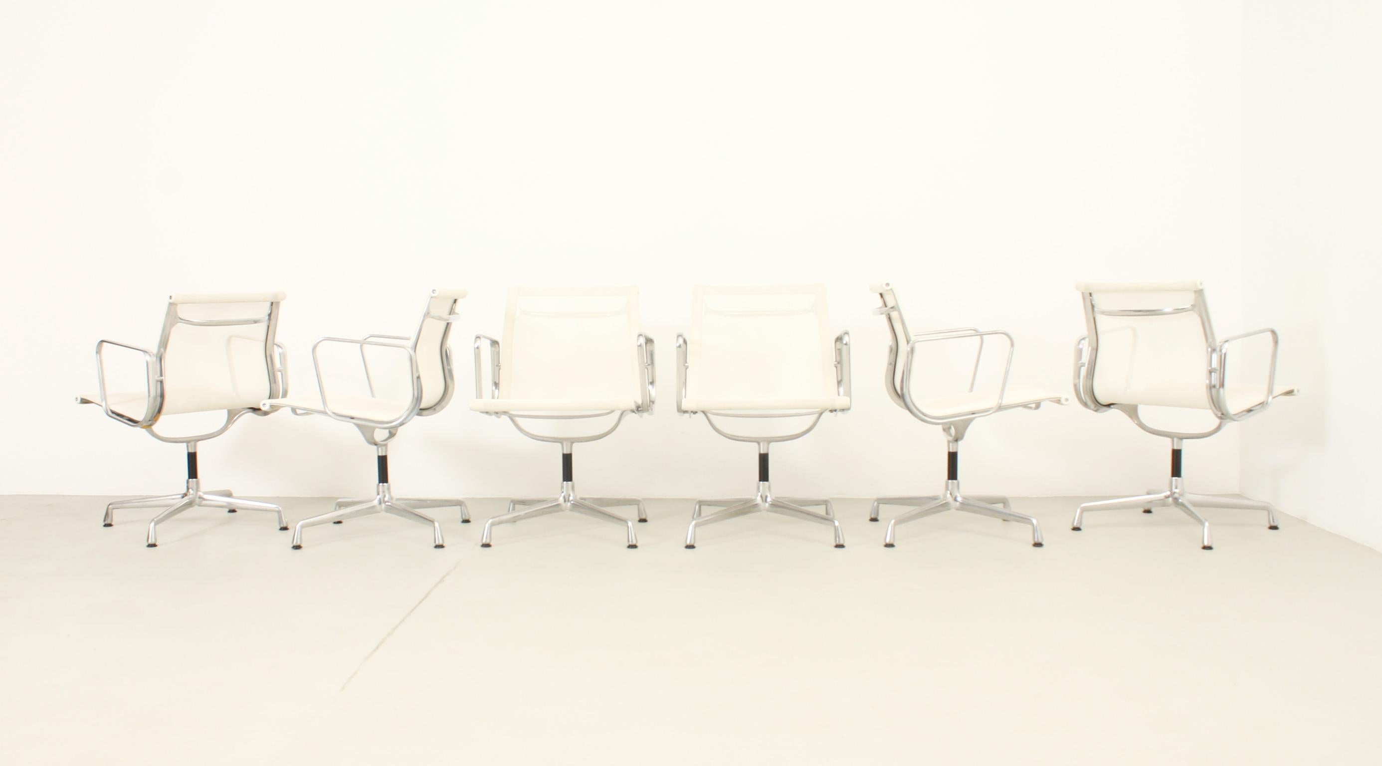 Set of six  Aluminum EA108 chairs designed by Charles and Ray Eames in 1958. Chromed-plated aluminum base and white net-weave seat with swivel mechanism. Vitra edition, signed, with 18 years old.