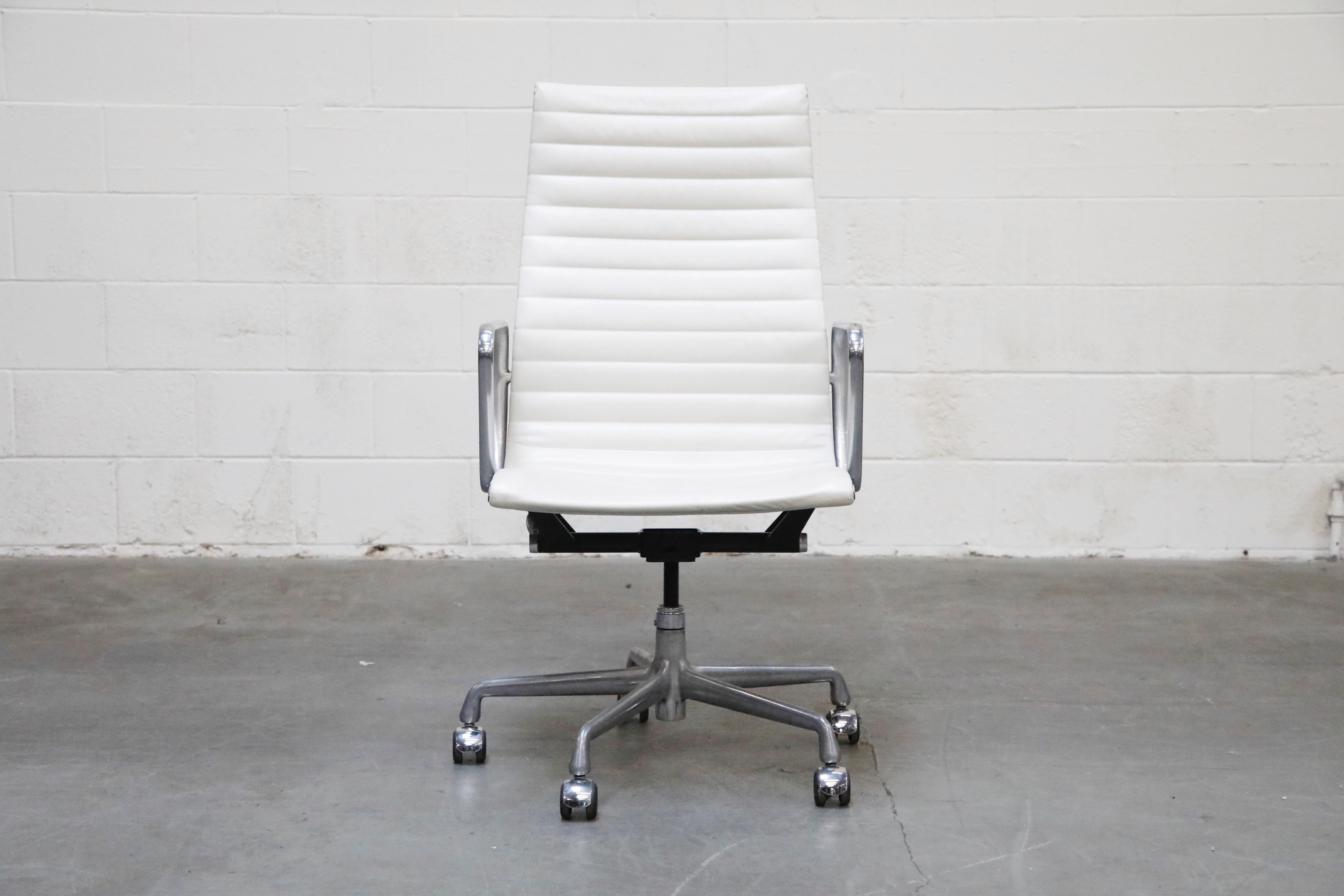 A stylish white leather 'Aluminum Group' Executive Desk chair by Charles and Ray Eames for Herman Miller. This example was part of their 50 Years commemorative label line produced only that year. Signed underneath seat with Herman Miller labels and