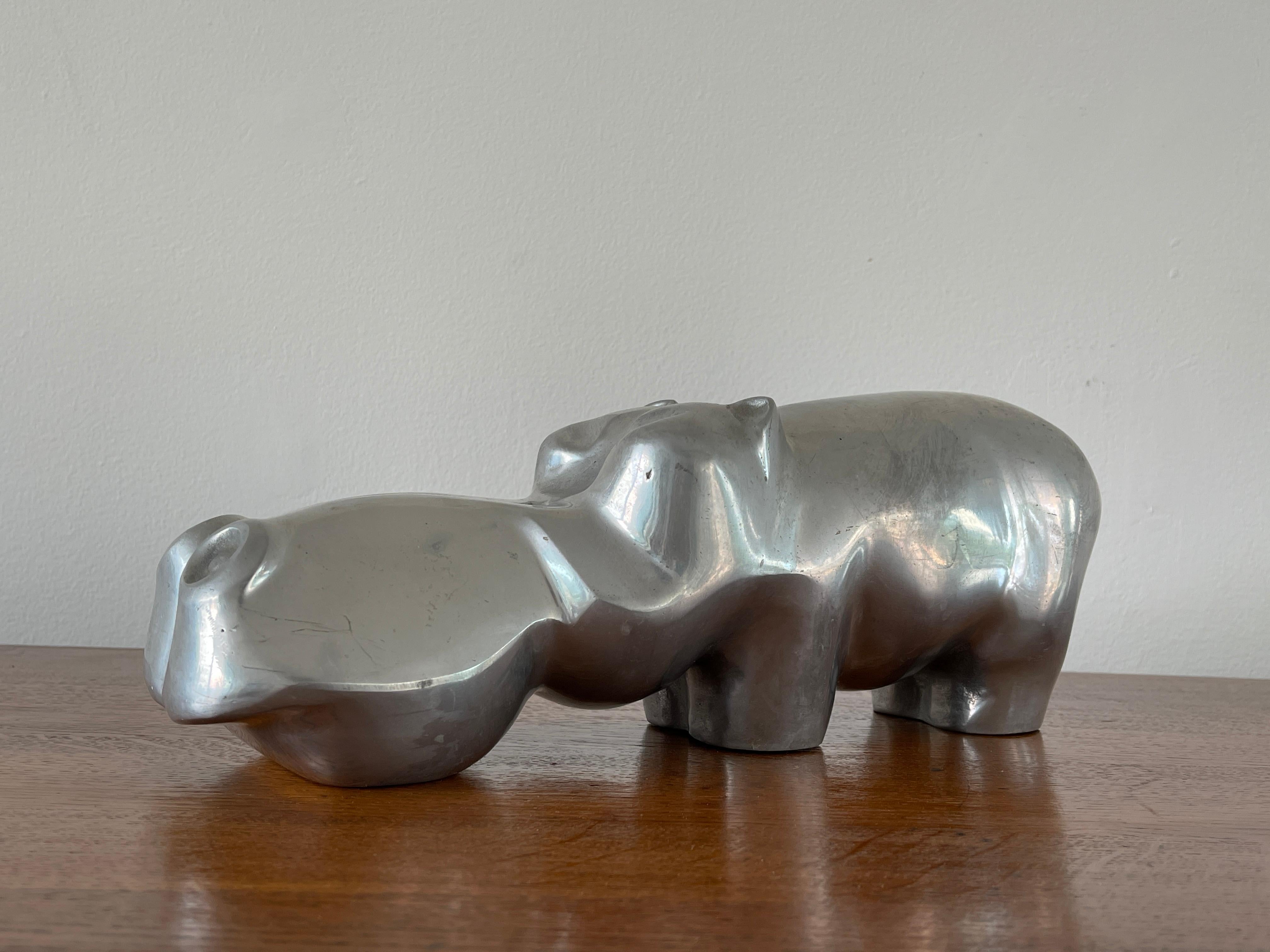 Cast aluminum Hippopotamus sculpture by David Parkin.
PARKER series - Signed and numbered 260/450.--
 Dimensions: H: 6.5 inches: W: 5 inches: D: 15 inches ---.