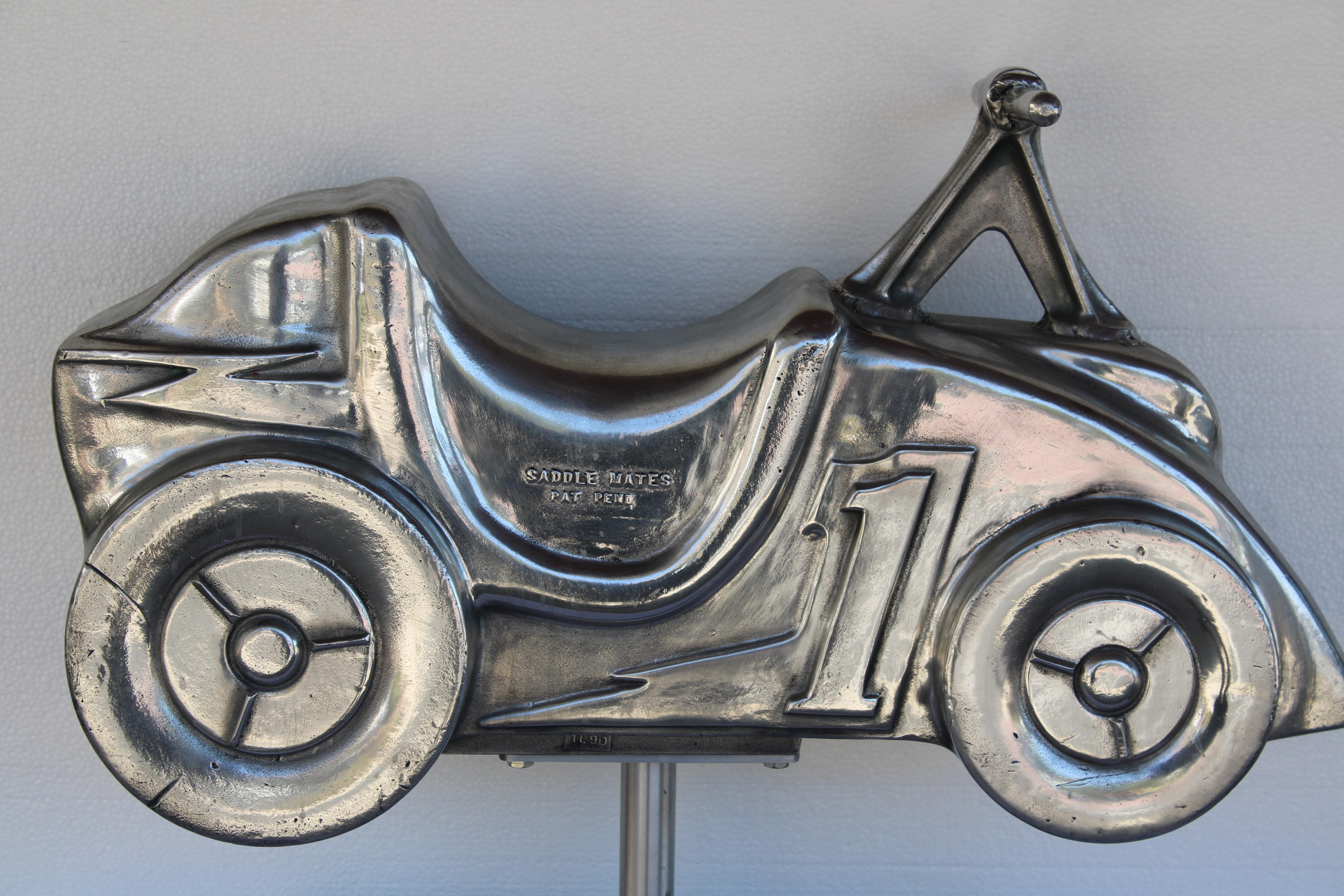 This aluminum motorcycle sculpture was originally a playground spring ride located throughout parks. Spring is not included. Motorcycle has been high polished and put on an aluminum stand.  It's more sculptural and part of Americana history. 