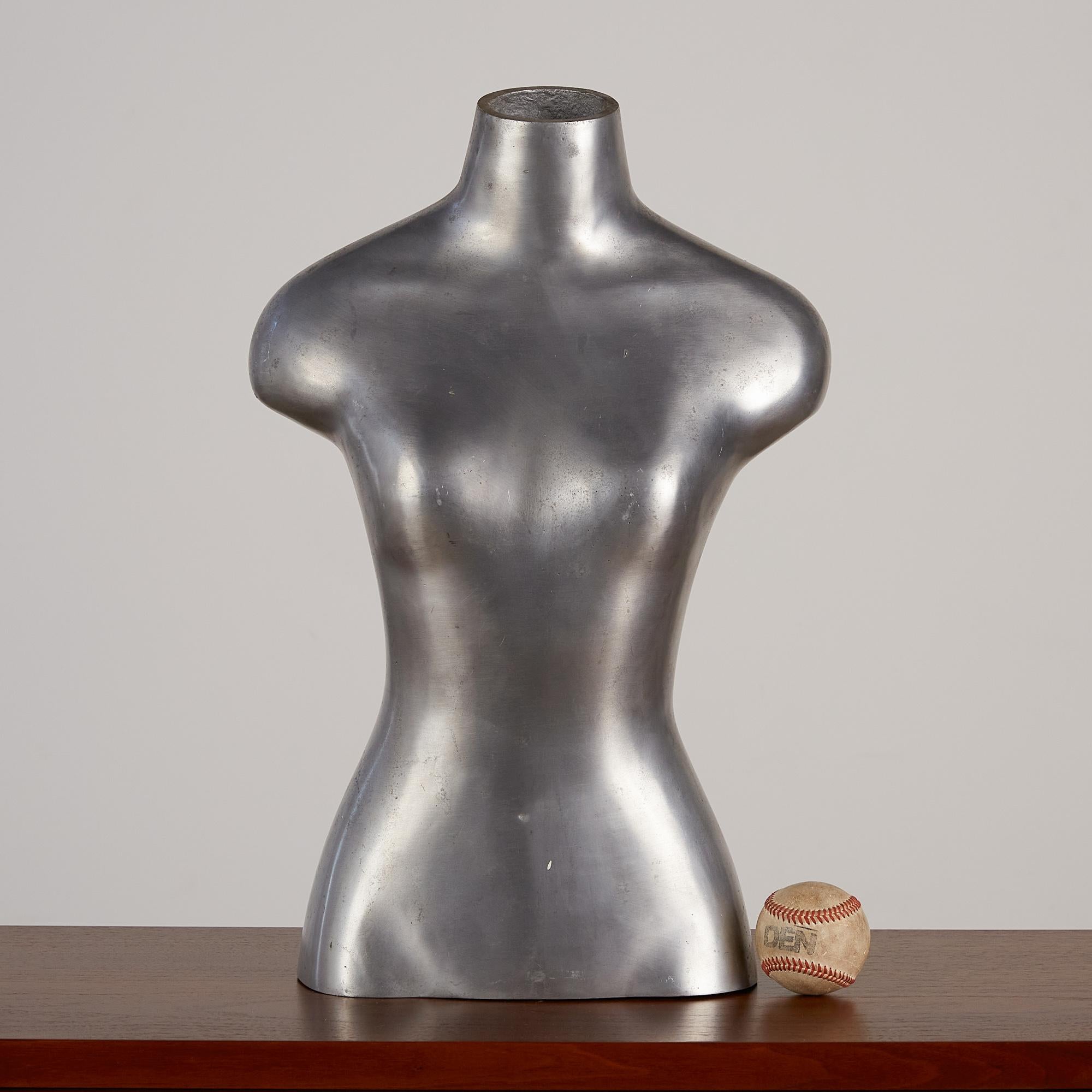 Made out of a material far more interesting than your standard dress form, this oddly unique, mannequin torso is both playful and sleek. A true statement piece that would be well suited as is on a credenza or shelf, it can also be mounted on a post