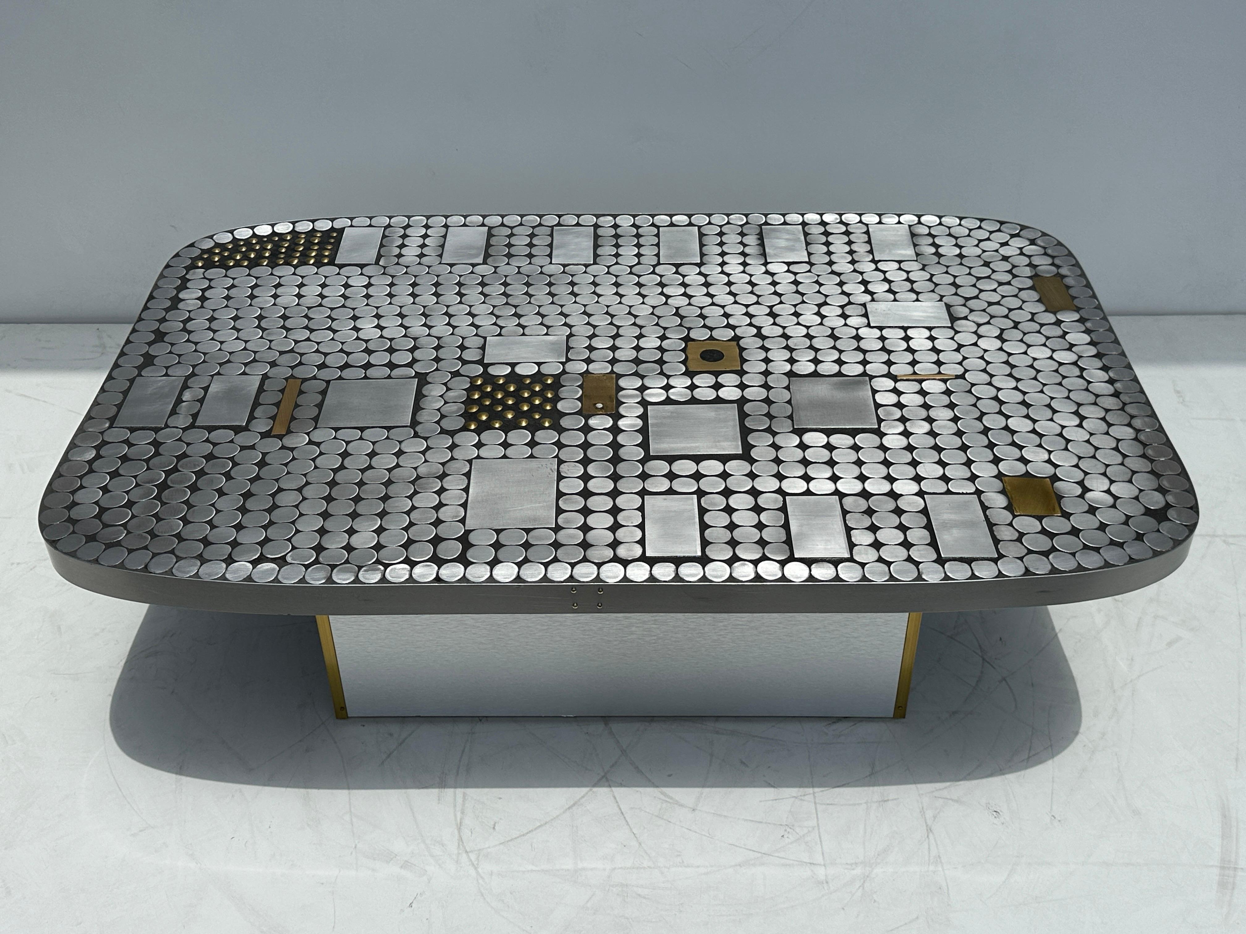 Brutalist Aauminum mosaic coffee table with brass detailing by Belgian artist furniture maker Raf Verjans 




Similar to designs by Paul Evans, Billy Joe McCarroll and David Galespi Heroic doors.