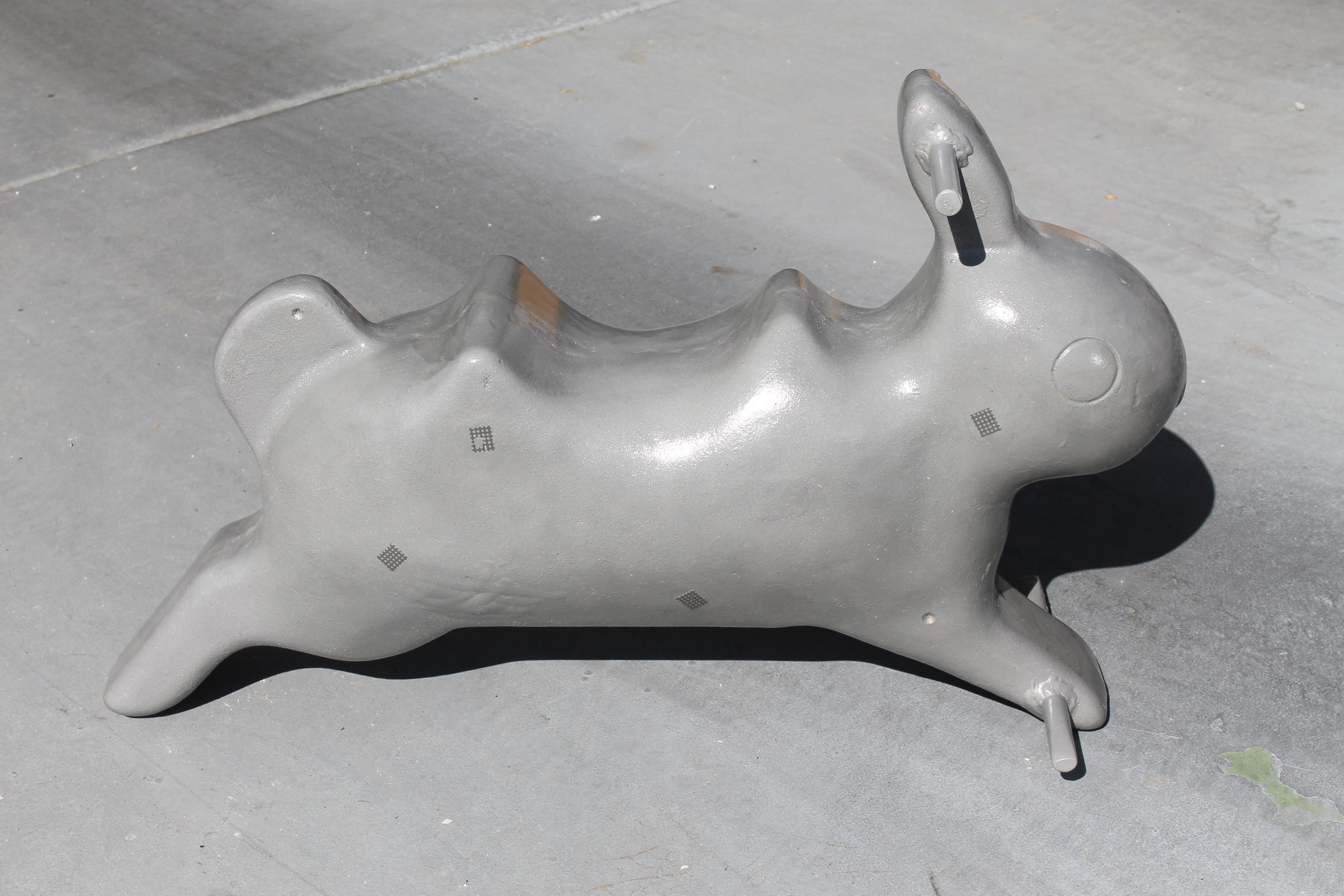 This aluminum rabbit sculpture was originally a playground spring ride located throughout parks. Spring is not included. It's more sculptural and part of Americana history. We had it sand blasted and clear coated. Rabbit measures 33