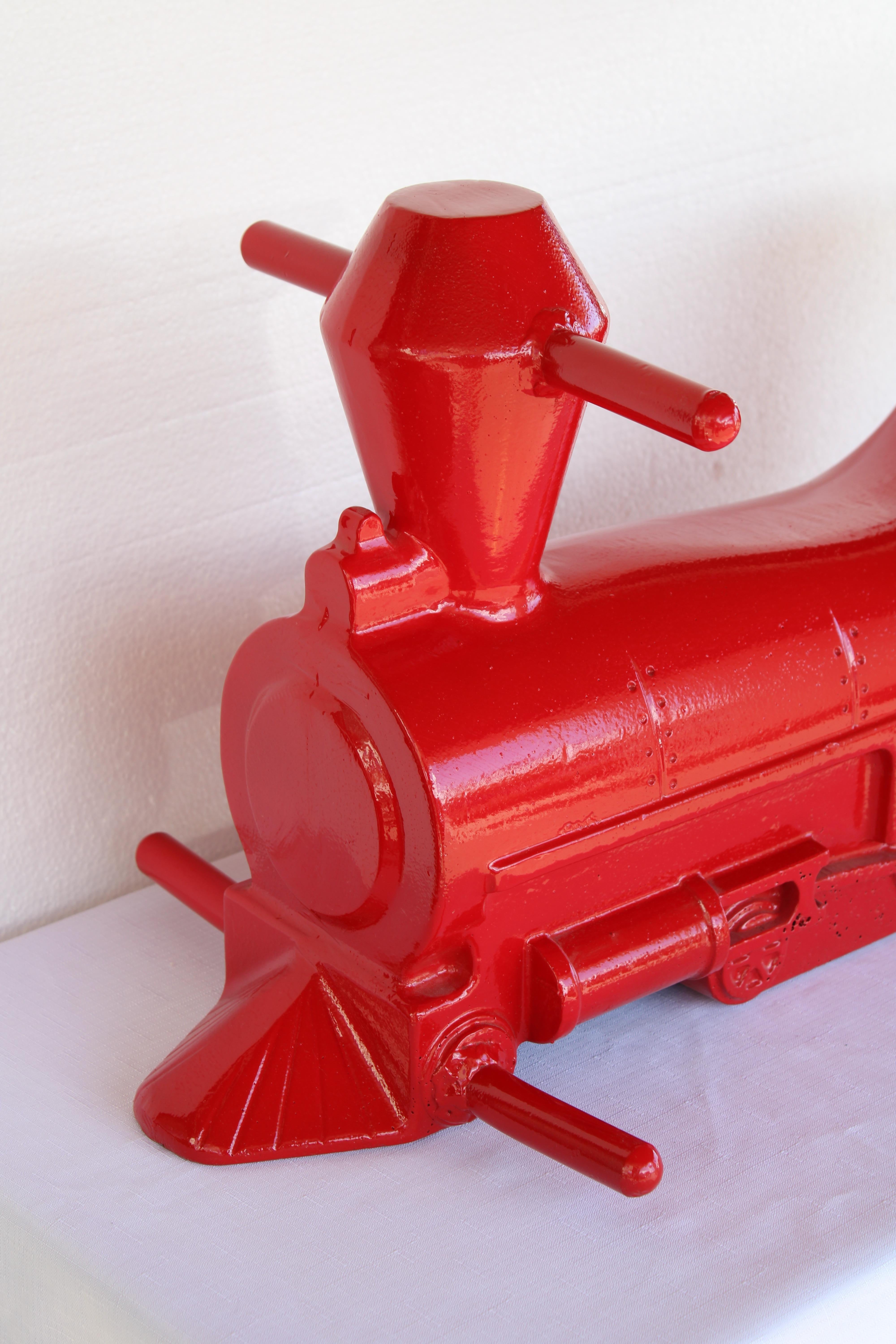 This aluminum locomotive sculpture was originally a playground spring ride located throughout parks.  Spring is not included. It's more sculptural and part of Americana history.  We had this locomotive sand blasted and powder coated red.  Locomotive