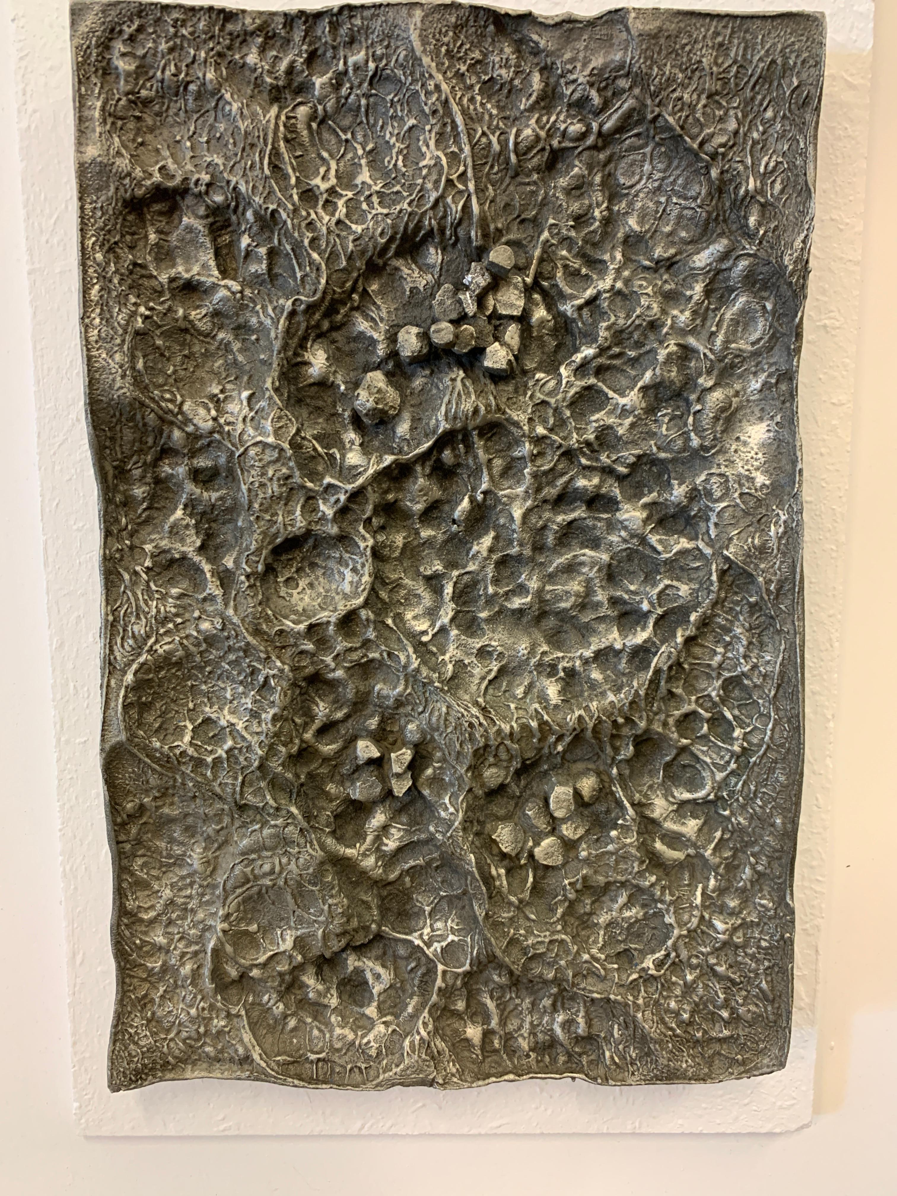 A mounted cast aluminum relief titled 