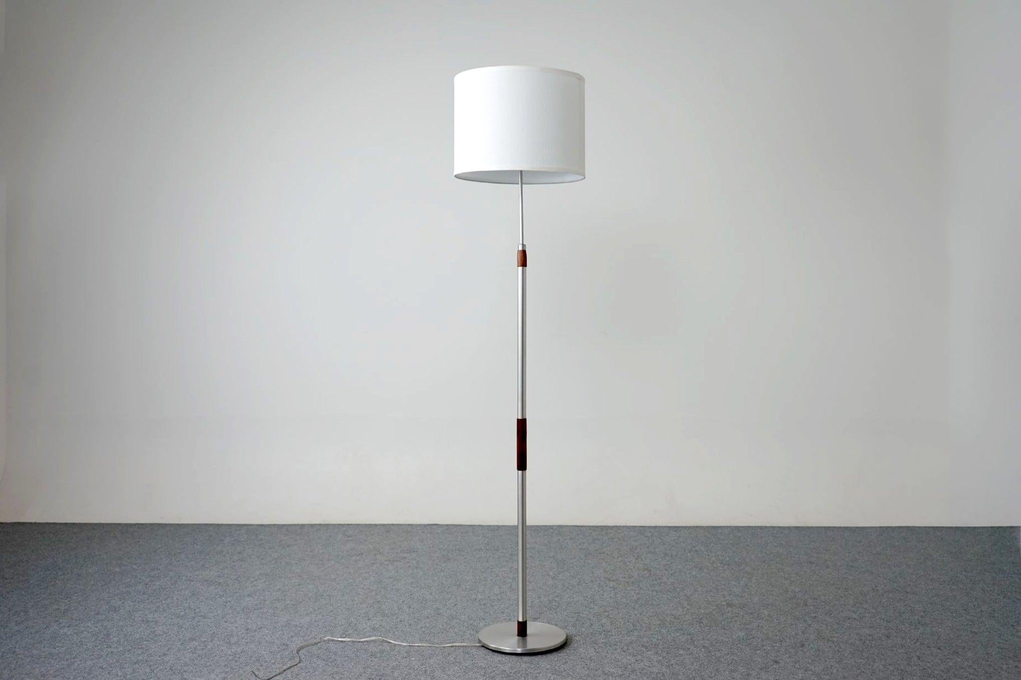 Rosewood and aluminum floor lamp, circa 1960's. This sleek contemporary beauty has a tri-light socket, allowing for 3 brightness levels to suit different lighting requirements. Updated electrical and a crisp, fresh custom shade in high quality