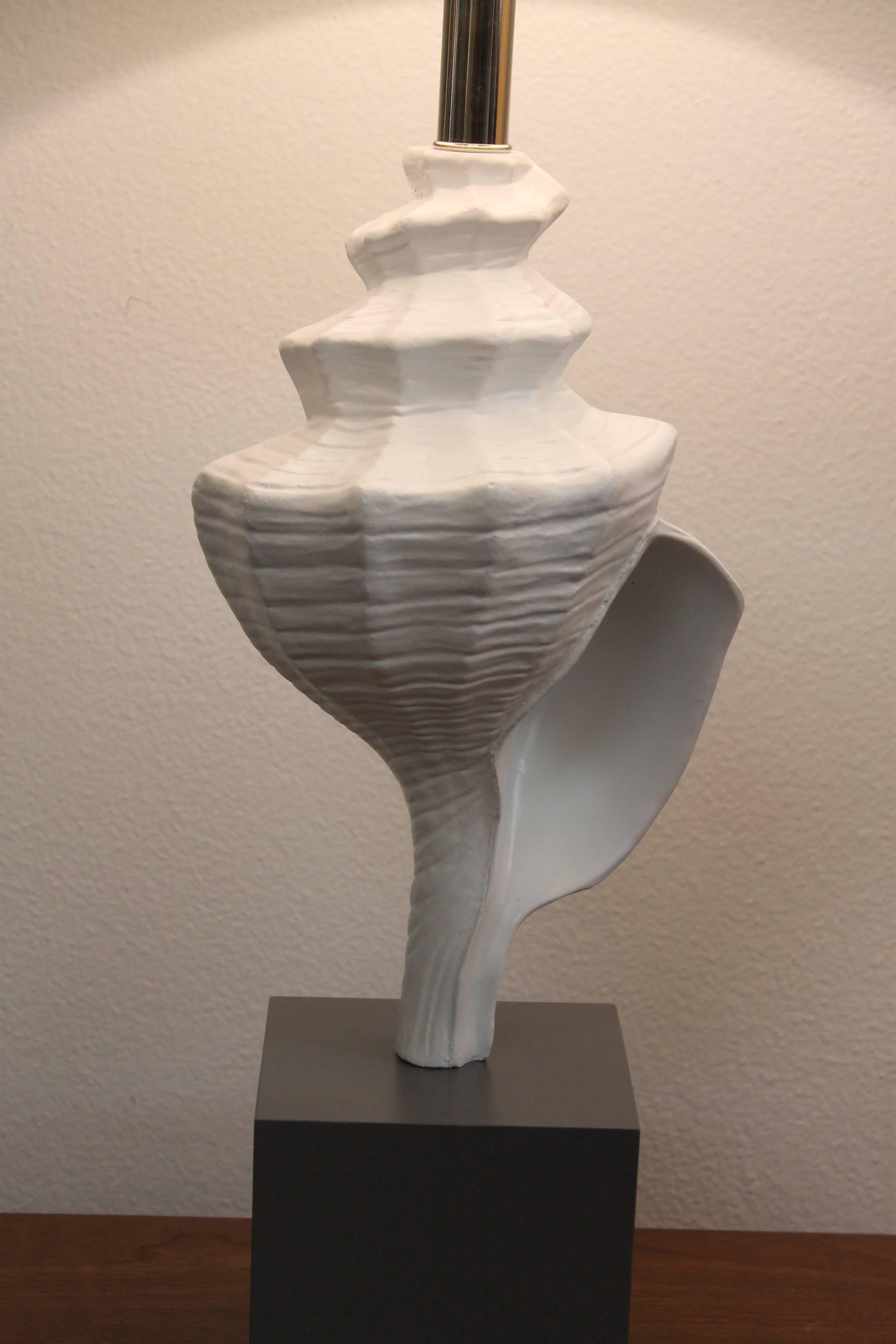 Aluminum seashell lamp attributed to the Laurel Lamp Company, Newark, New Jersey. The seashell is 13.25” high. Total height from base to the bottom of socket is 21.5”. Measure: Base is 5.5” wide, 5.5” deep and almost 5” high. Lamp has been