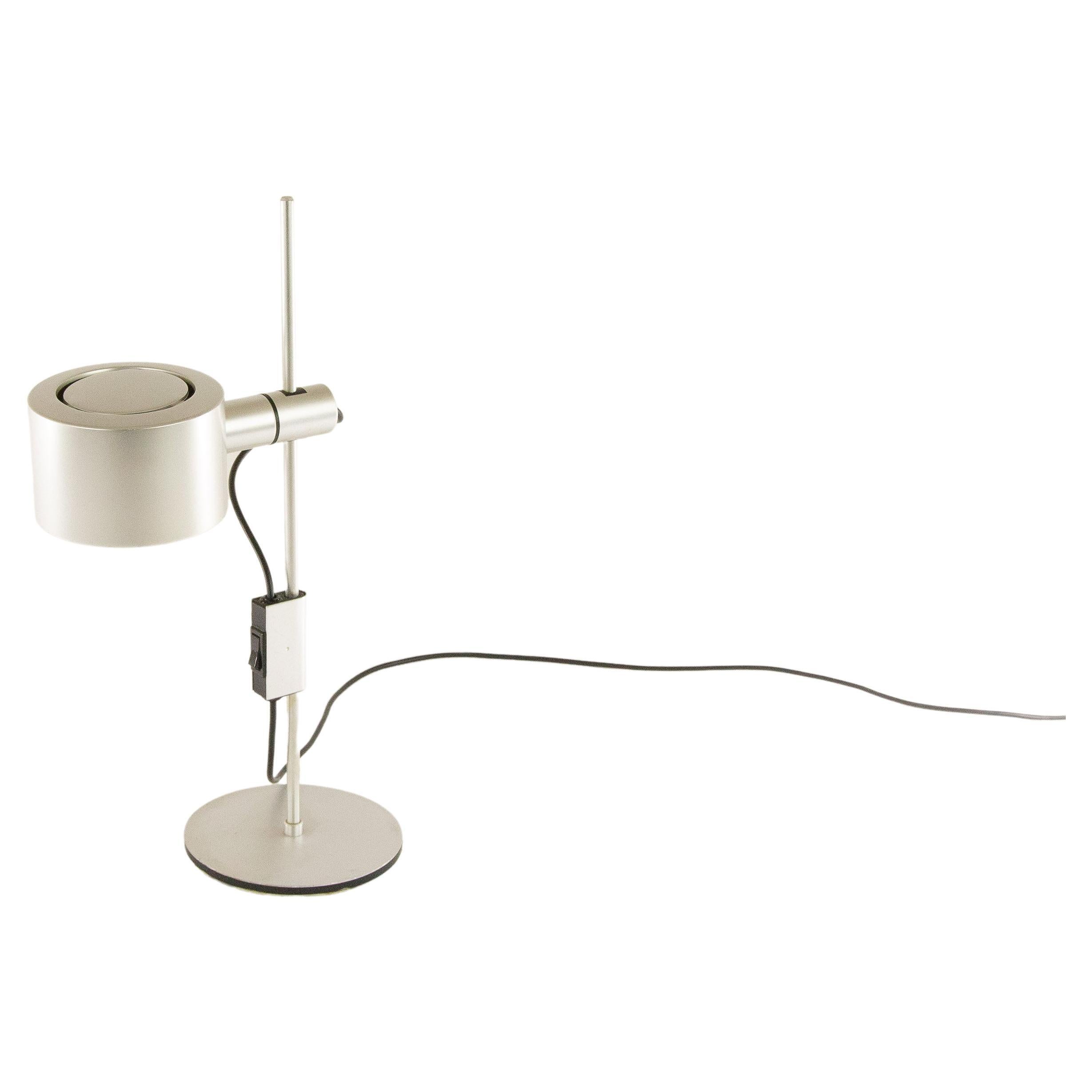 Aluminum desk lamp by Ronald Homes for Conelight Limited. The shade of the lamp is adjustable in height and rotatable.

This model is regularly wrongly attributed to Architectural Lighting Company (designer Peter Nelson), to Baltensweiler and to