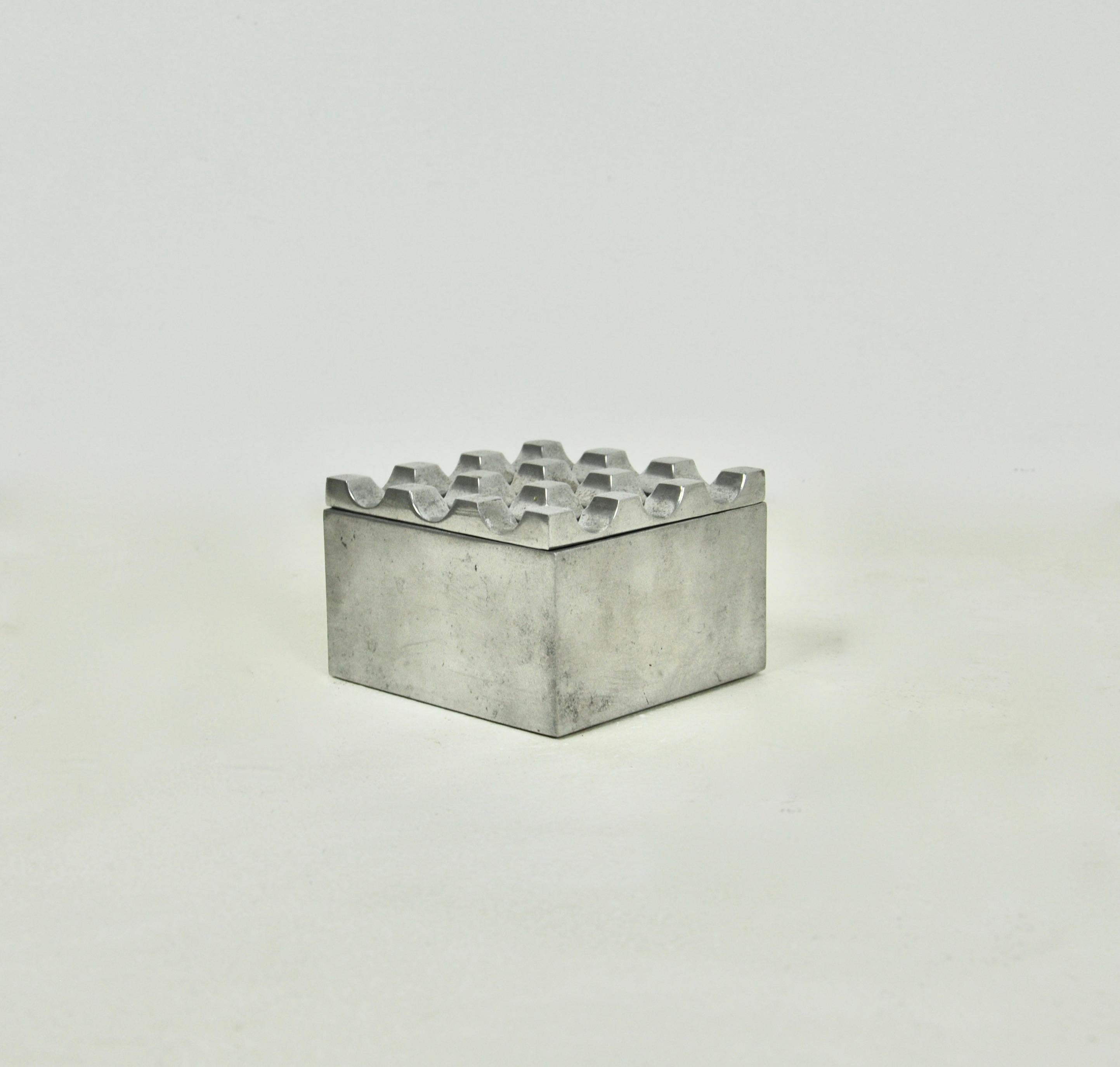 Square aluminum ashtray. Stamped Ultima. Wear due to time and age of the ashtray.