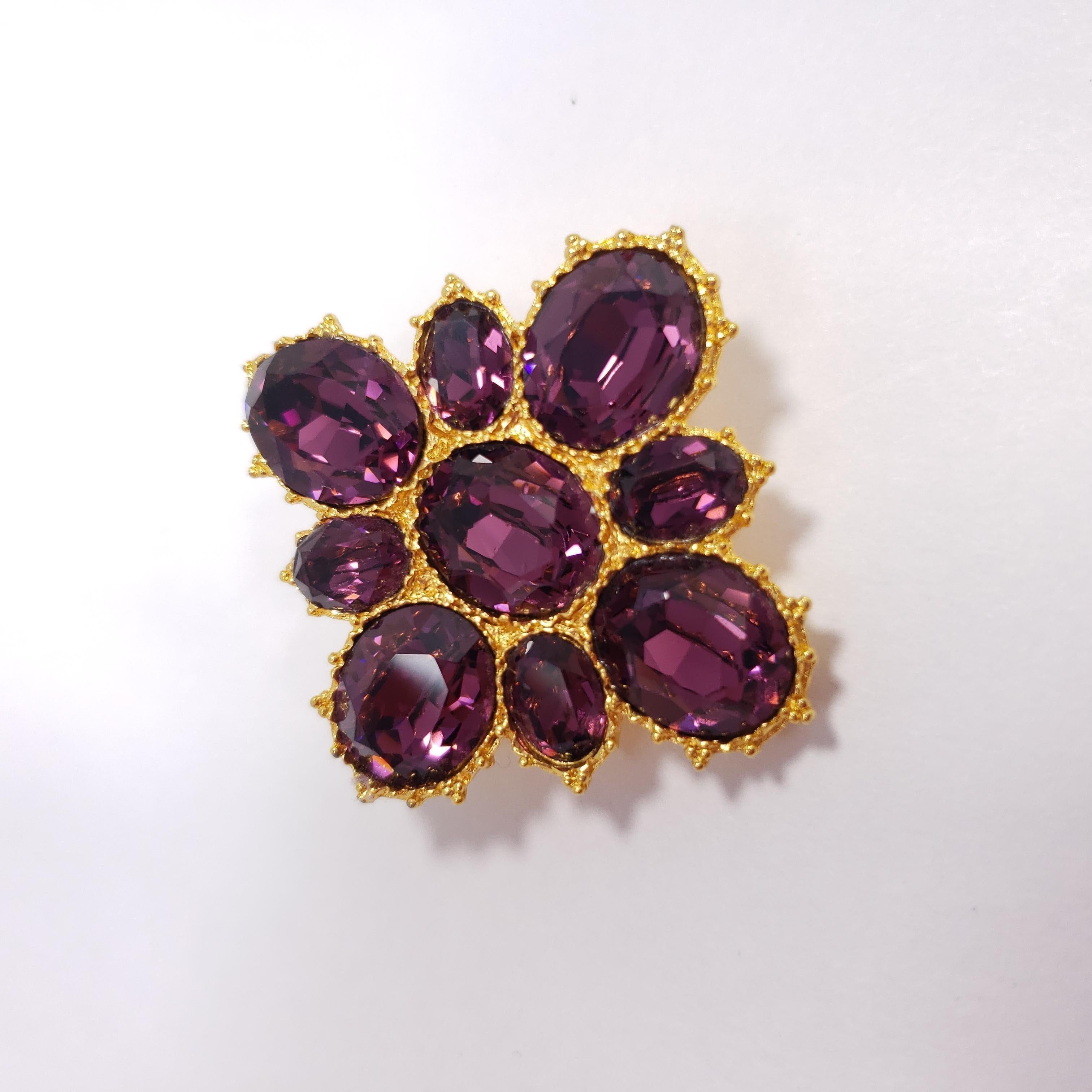 This glamorous 20th century Maltese cross-inspired pin is decorated with amethyst crystals. For a sophisticated and regal look!

Gold-plated. Made by Alva.

Marks / hallmarks / etc: Alva