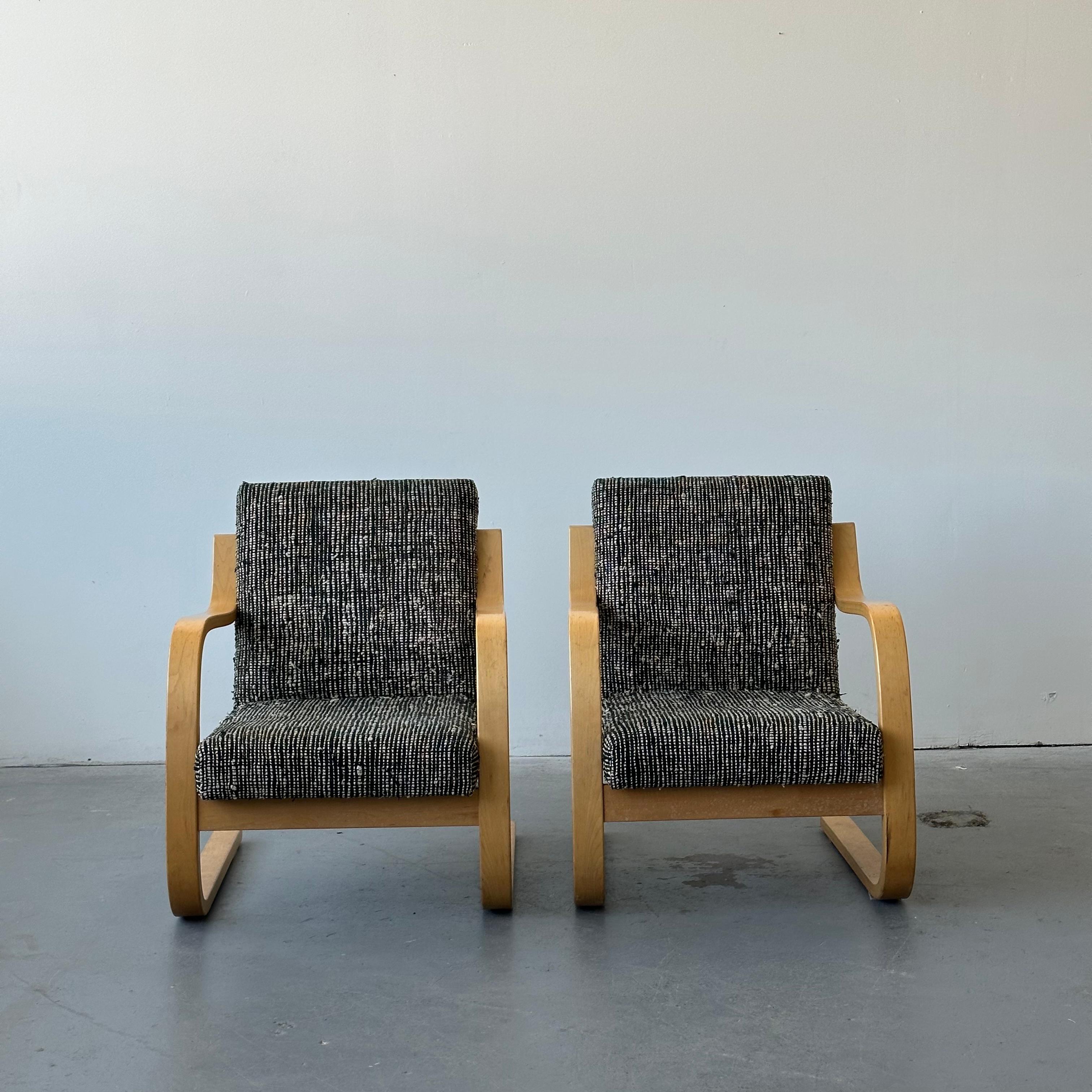 c. 1970s, both chairs are stamped to ensure age and authenticity and retain their original upholstery. There are no holes or rips in the fabric but you can see the wear easily in the photos. The frames themselves also have wear including small