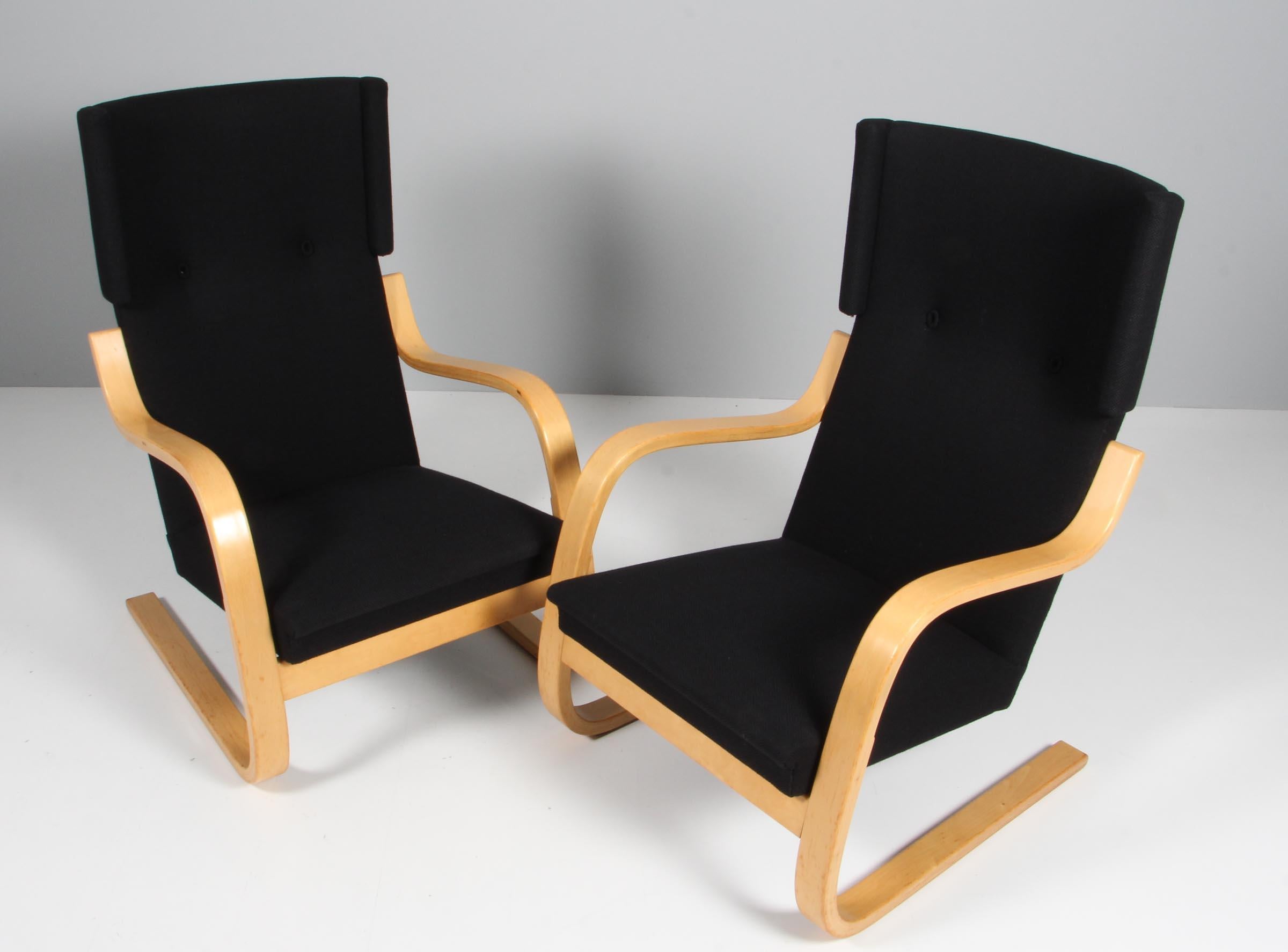 Lounge chairs / Winback chairs designed by Alvar Aalto manufactured, circa 1970s.

Original upholstered with black fabric.

Curved birch plywood and braided vegetable fiber. 
Measures: 74 x 61 x 69 cm.
 
