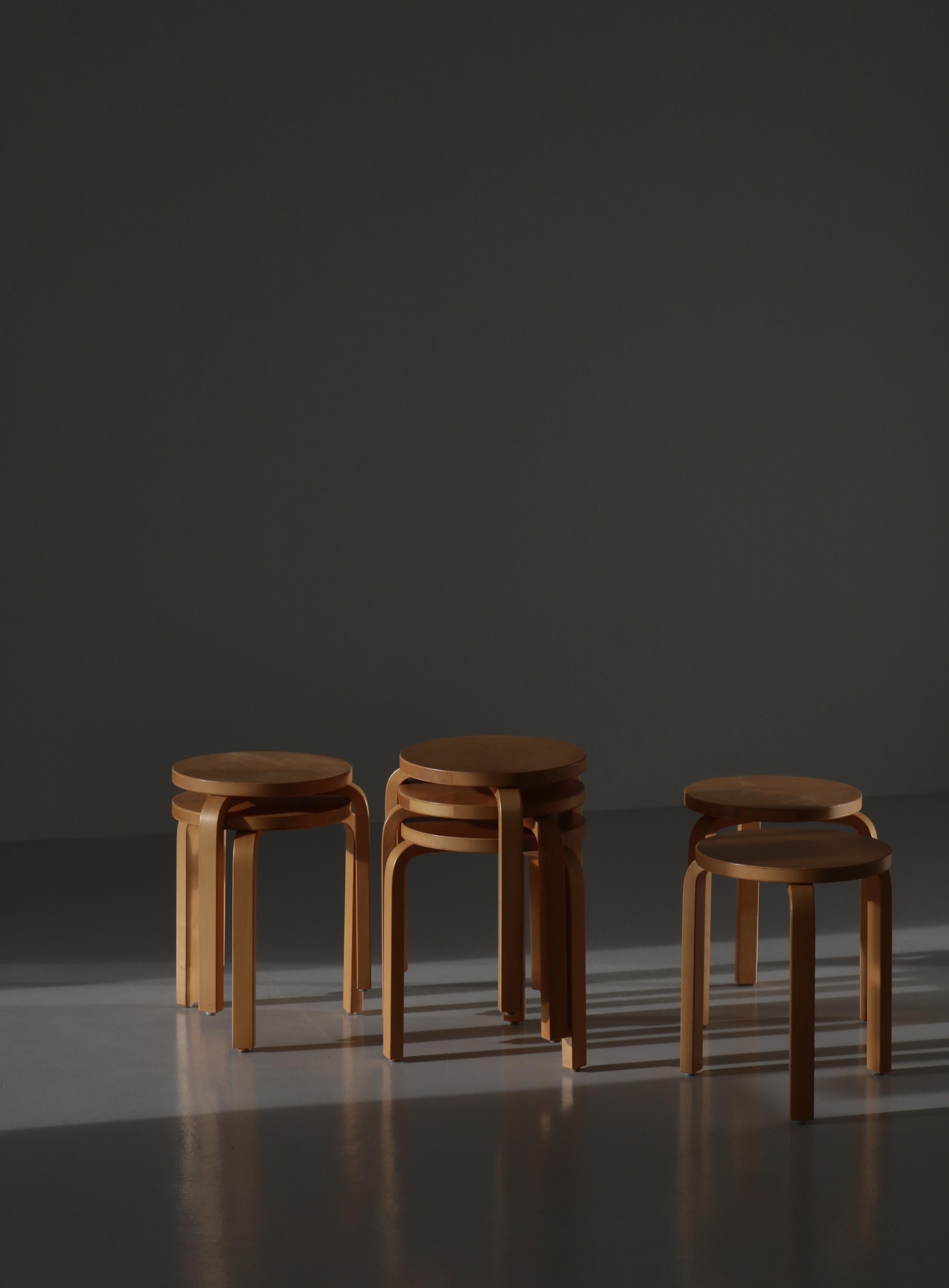 Set of 7 beautifully patinated L-leg stools by Alvar Aalto in laminated birch. Bought in Denmark in the 1970s at Paustian.
Alvar Aalto’s Three-legged stool model 60 designed in 1934 is the most elemental of furniture pieces, equally suitable as a