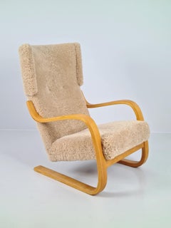 Poltrona Alvar Aalto Modello 401 in betulla e pelle di pecora color miele, Artek anni '50