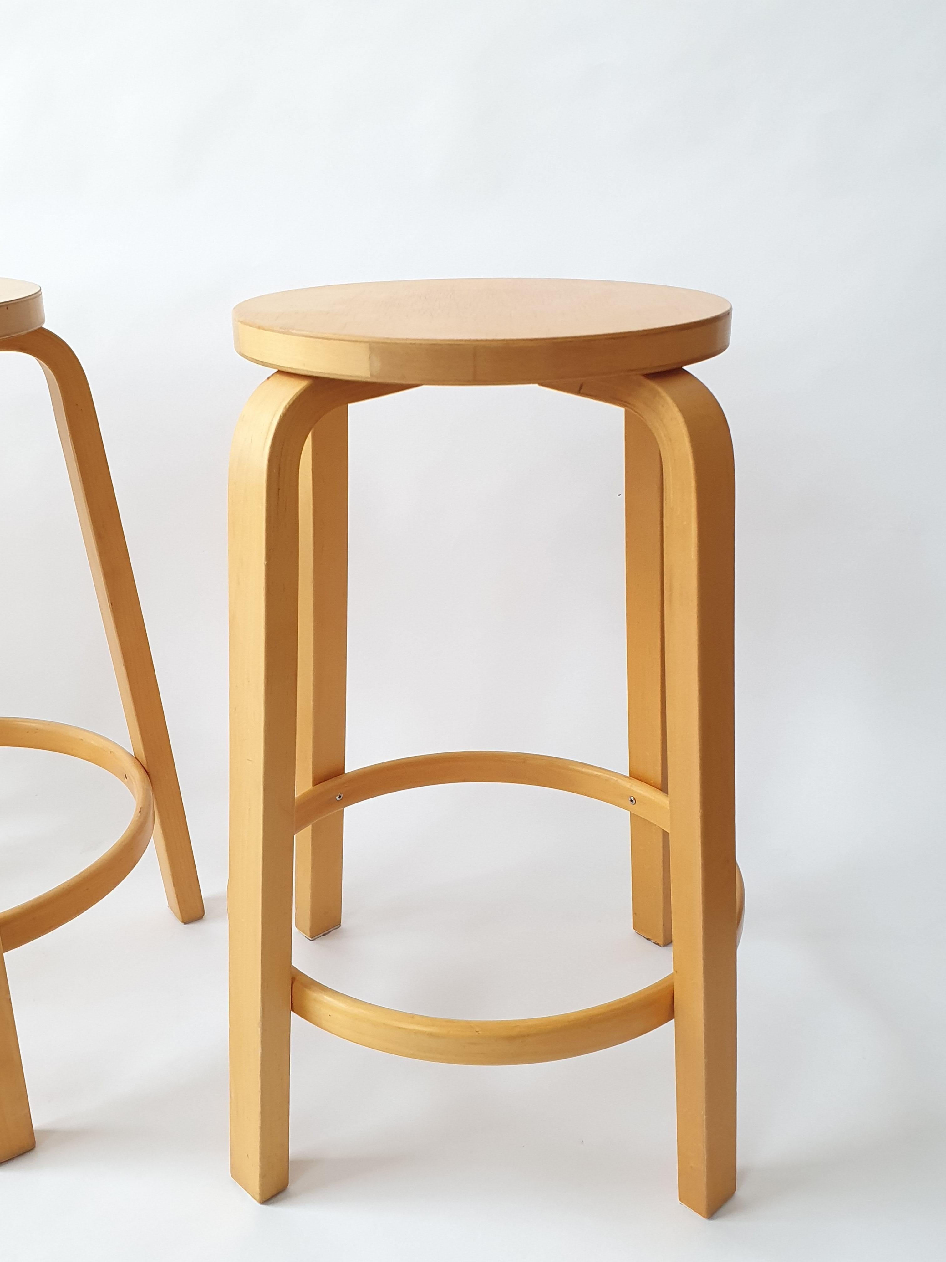Artek 64 bar stools, designed by Alvar Aalto. These stools are from 1970s. They are in good used condition. 
