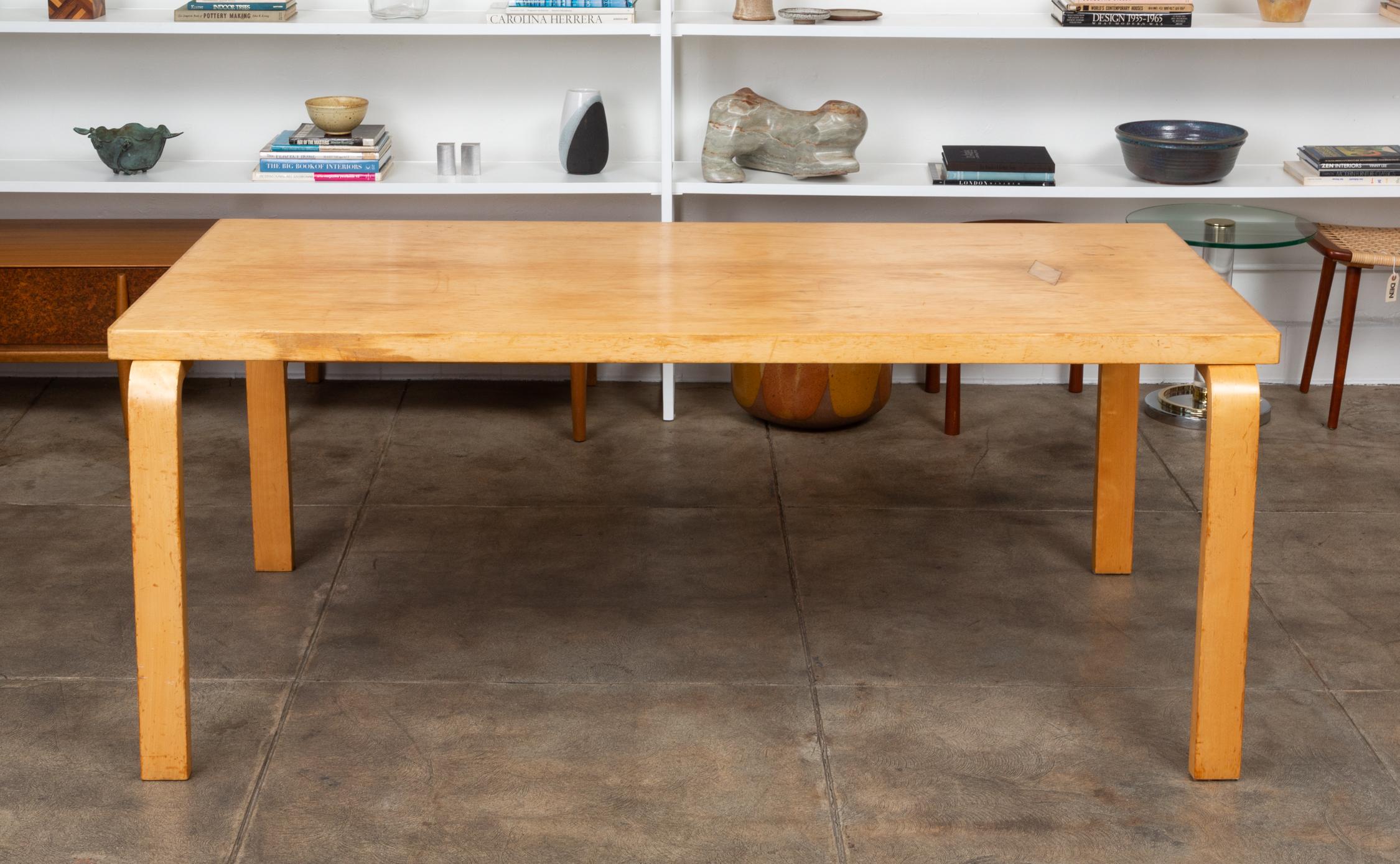 A dining table by Alvar Aalto, Finland, circa 1940s. The table features a rectangular birch plywood top that sits atop bentwood legs. This design features Aalto’s signature method of joining table tops to table legs, by mounting with screws from