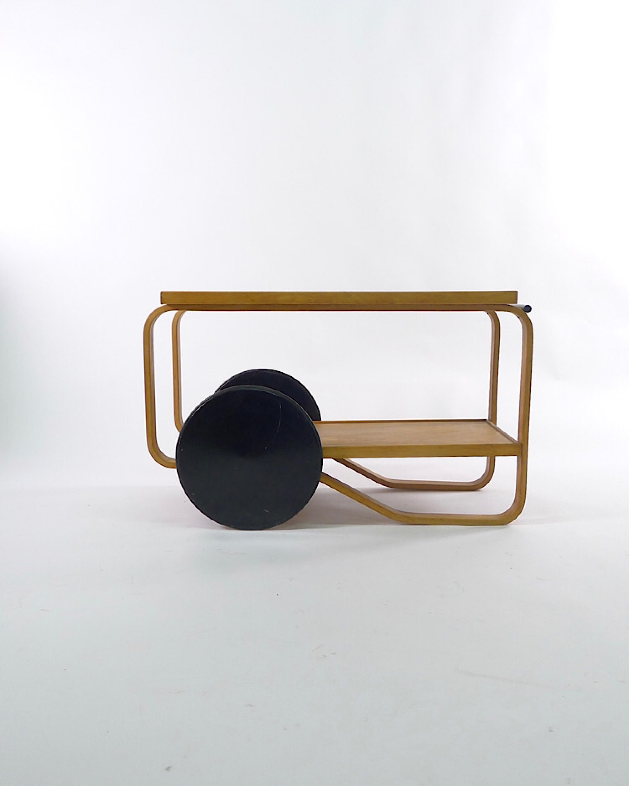 Alvar Aalto, model 98/901 serving trolley, for tea or drinks, designed in 1935 this is an early original example, bearing Finmar Ltd label, in birch plywood with black painted wheels.