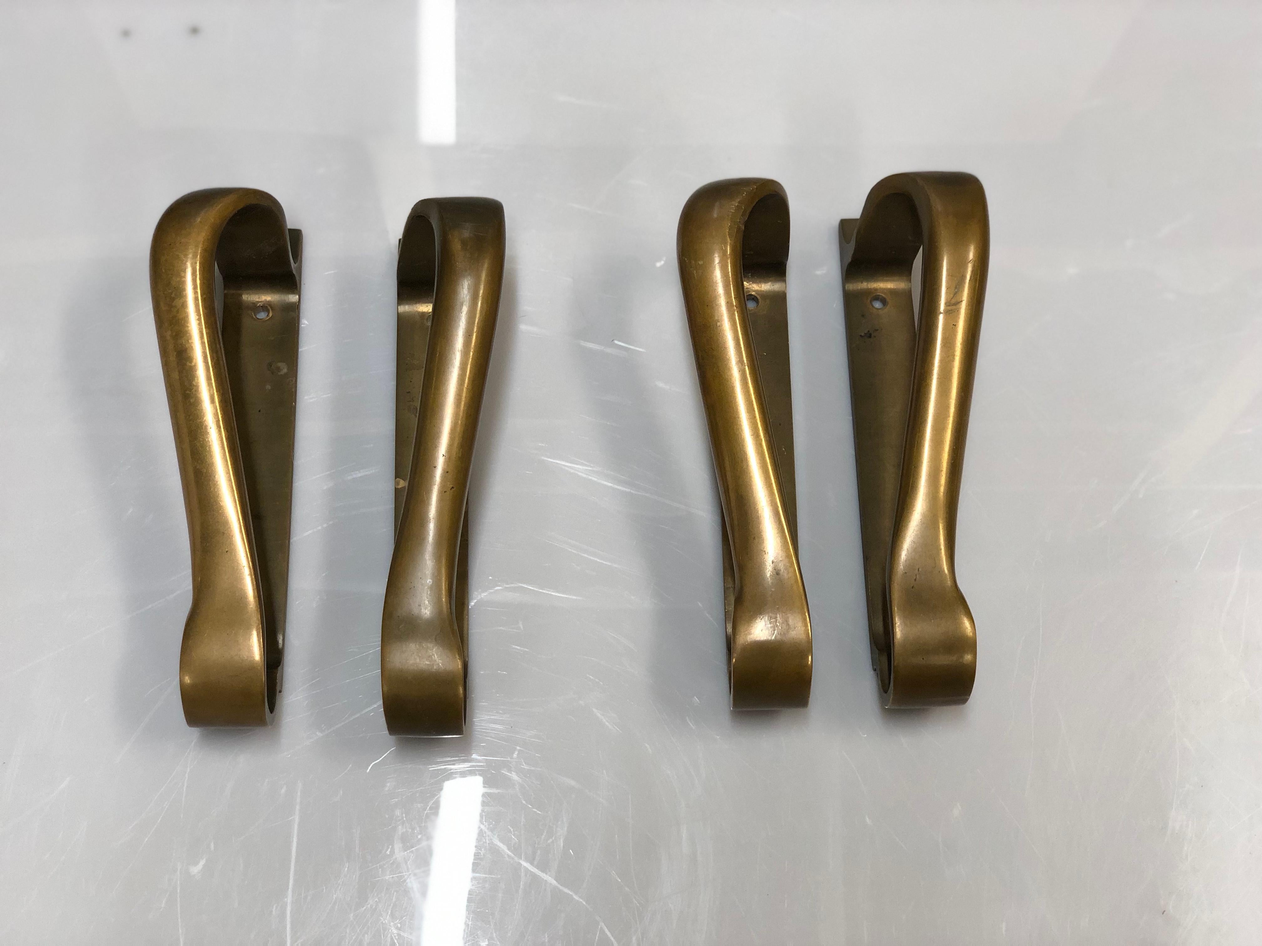 Two very distinct and elegant mid-century door handles in full bronze. Manufactured by valaistustyö and designed by Alvar Aalto himself. Very practical yet stand out pieces with guaranteed quality, craftsmanship, authenticity and design. Pieces like