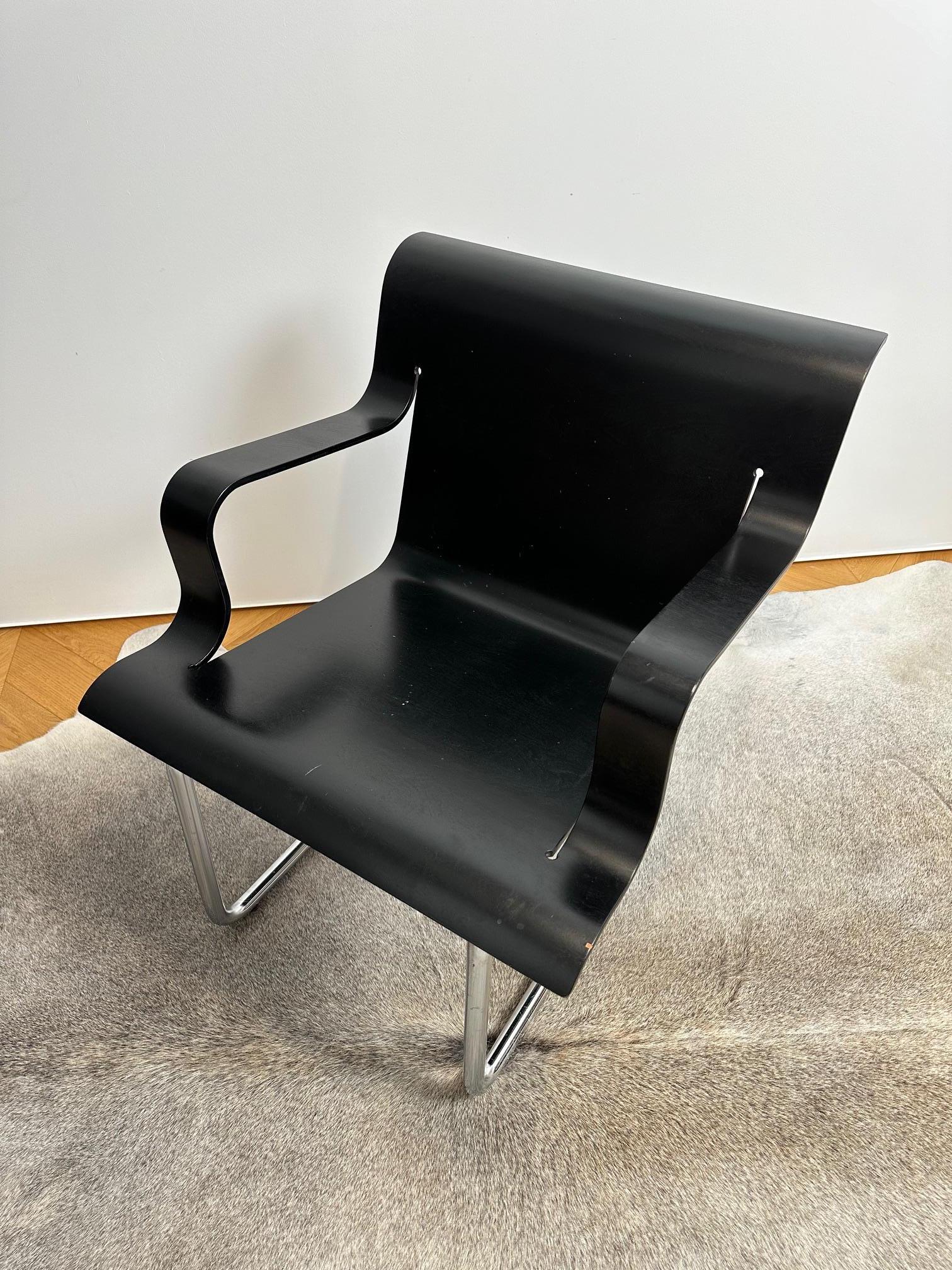 Very hard to find Model 26 armchair is designed by Alvar Aalto for Artek with frame in steel tube, painted matt black and with seat form pressed birch plywood, lacquered in black.

Aalto designed Lounge Chair 26 in 1932, but only a prototype was