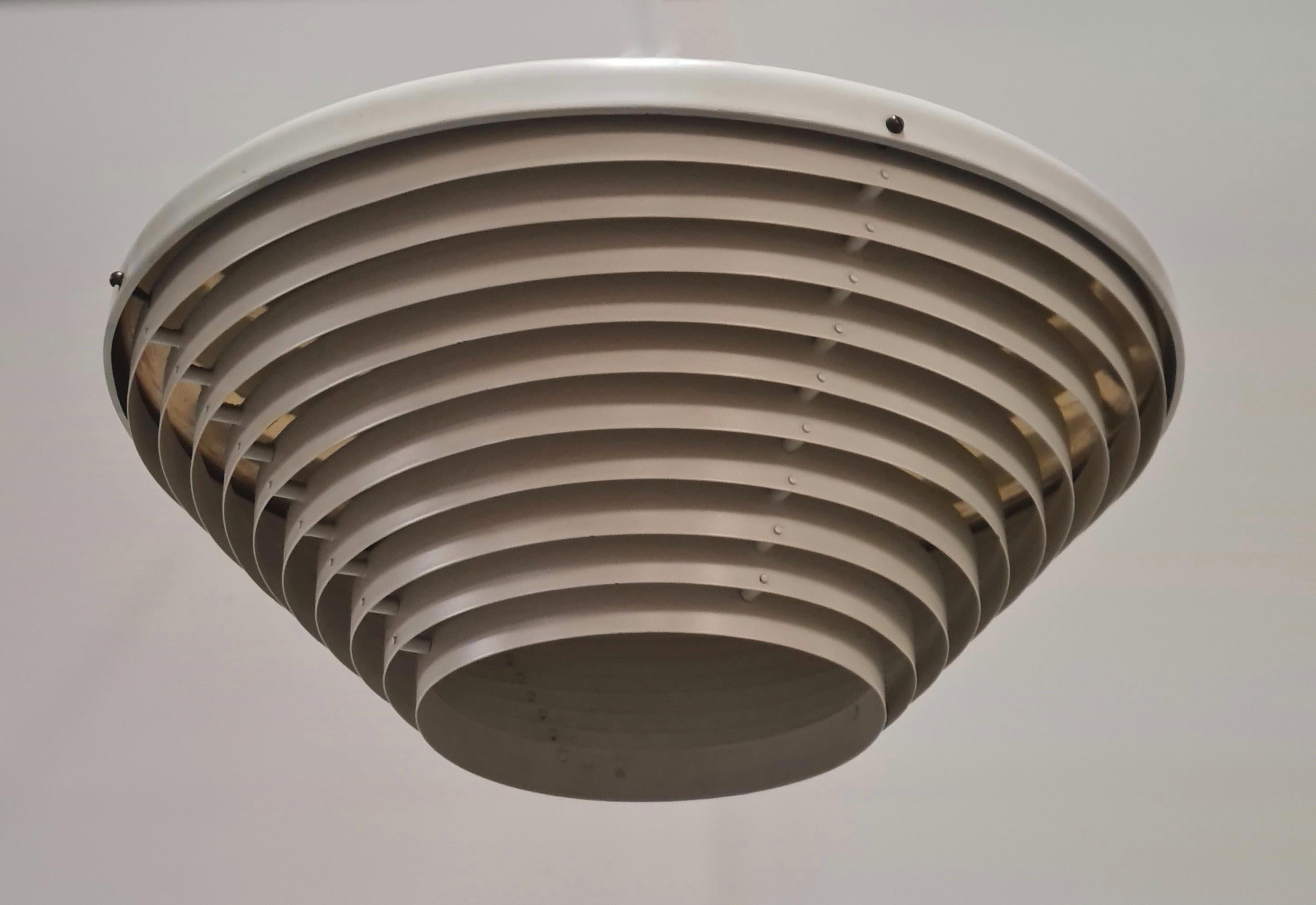 A ceiling pendant model A605 (The smaller version of the A622.) designed by Alvar Aalto and manufactured by Valaistustyö in Finland in the 1950s. In line with all Aalto furniture and lighting designs, this piece is very minimalistic and functional.