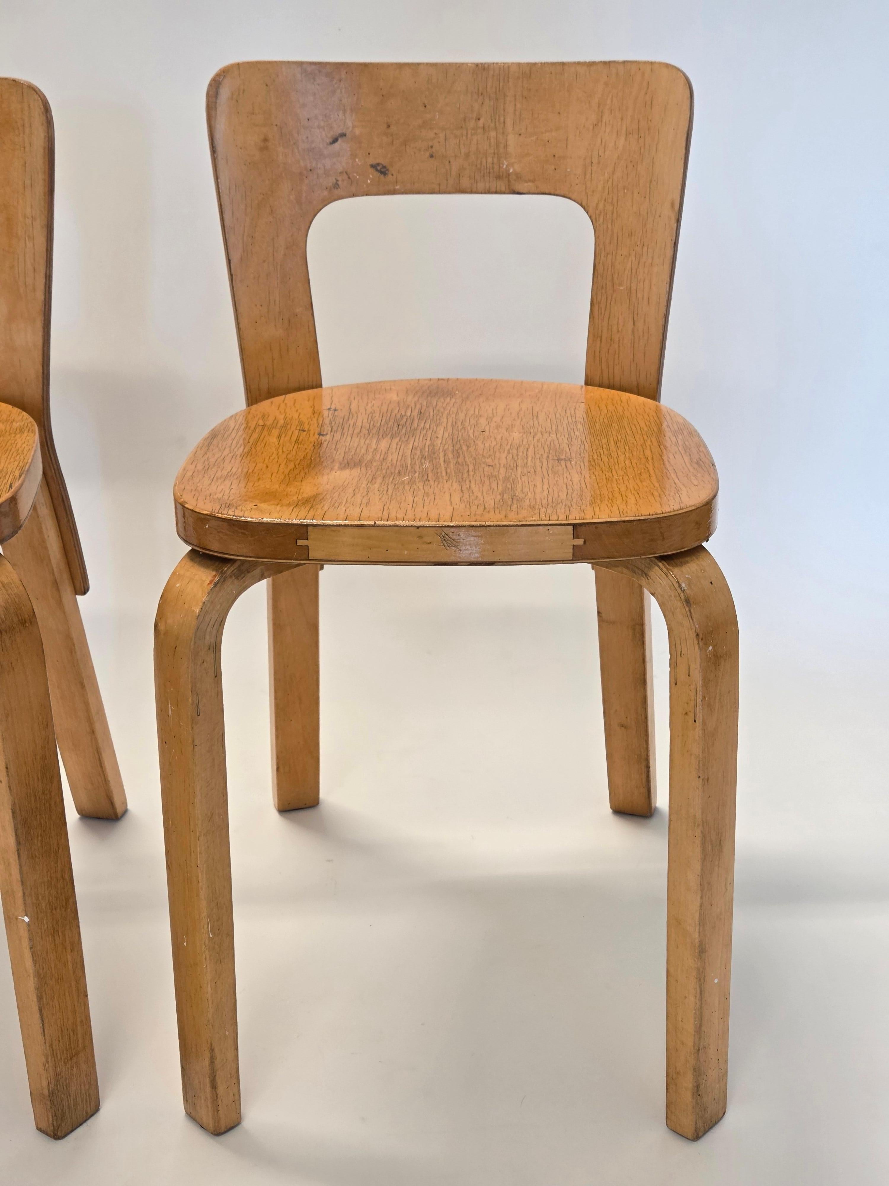 Artek A65 chairs 2 pcs, designed by Alvar Aalto. The chairs are from circa 1950s. Wonderfully patinated and in good condition. The chairs have finger joints in the seat, and slotted screws.

Alvar Aalto's A65 chair, designed in 1930s, is an elegant