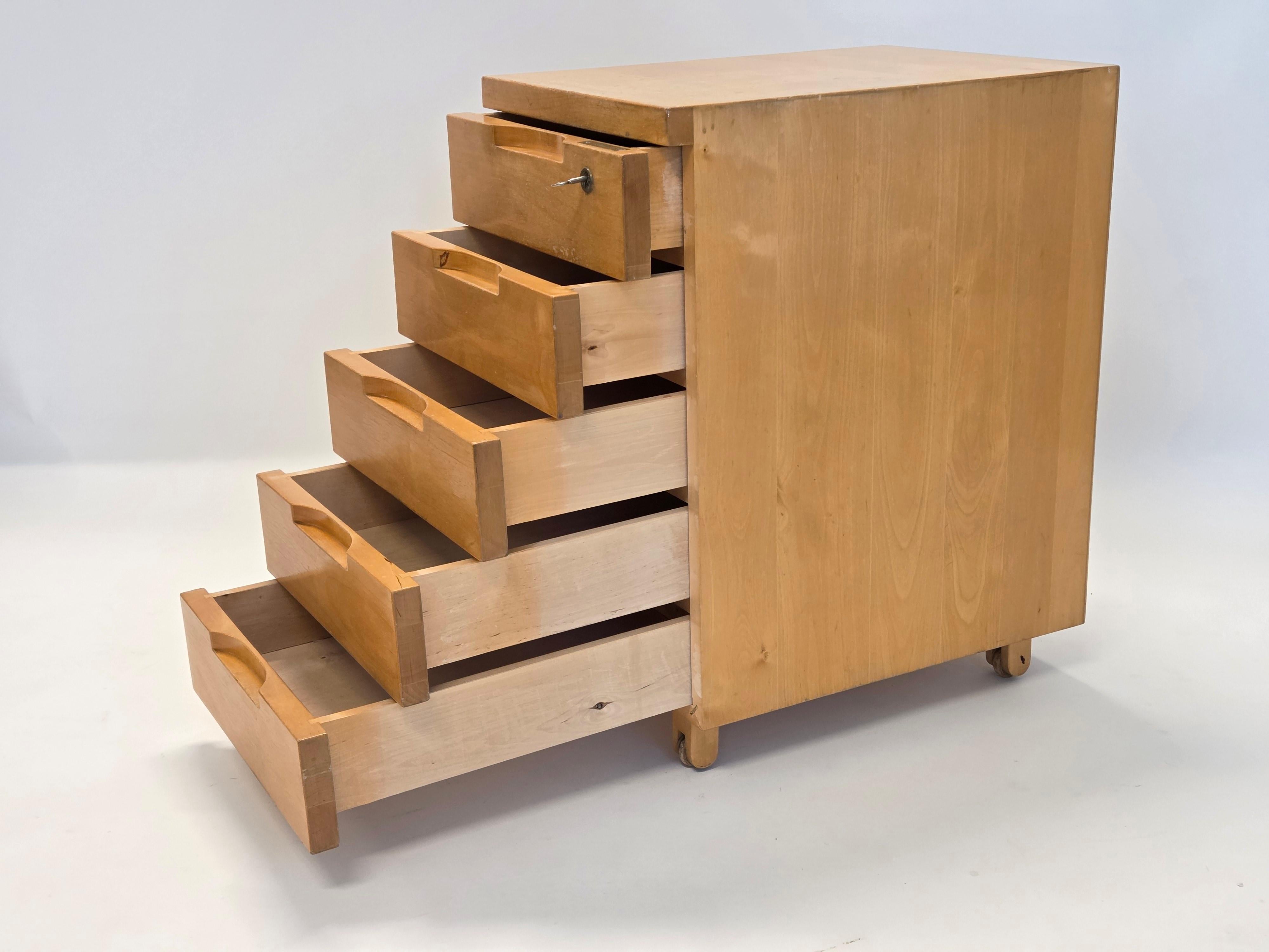Artek 297 chest of drawers, birch. Designed by Alvar Aalto. Good used condition and there is a key left. The bottom of the chest of drawers has four wooden wheels and an old Artek stamp. The chest of drawers is from around 1960s.