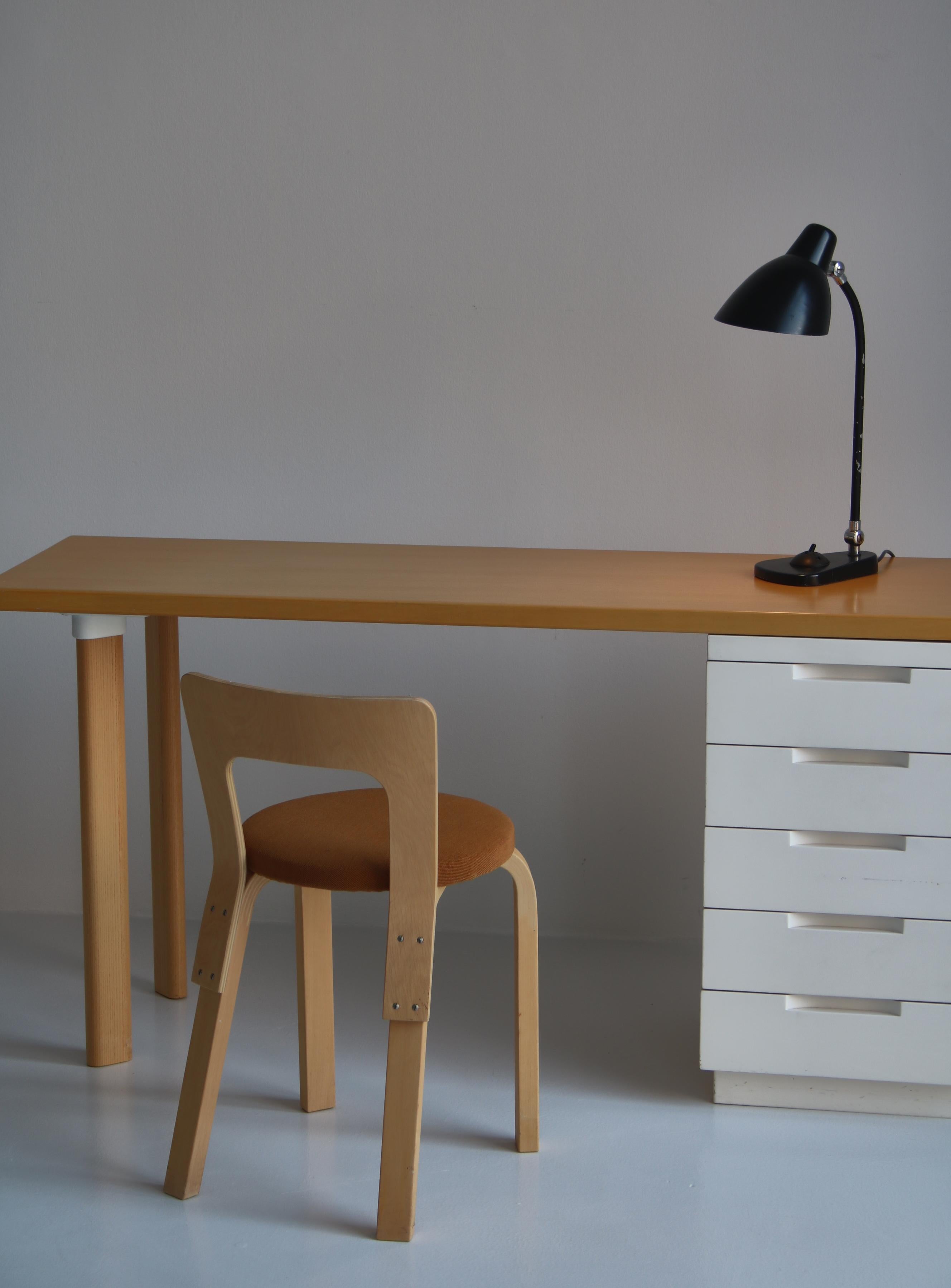 Alvar Aalto work table and chair model 65 in wonderful vintage condition made at Artek in the 1960s. Table is made of laminated elm and the chair is made of birch. Original wool upholstery on the chair. The cabinet still has the original white