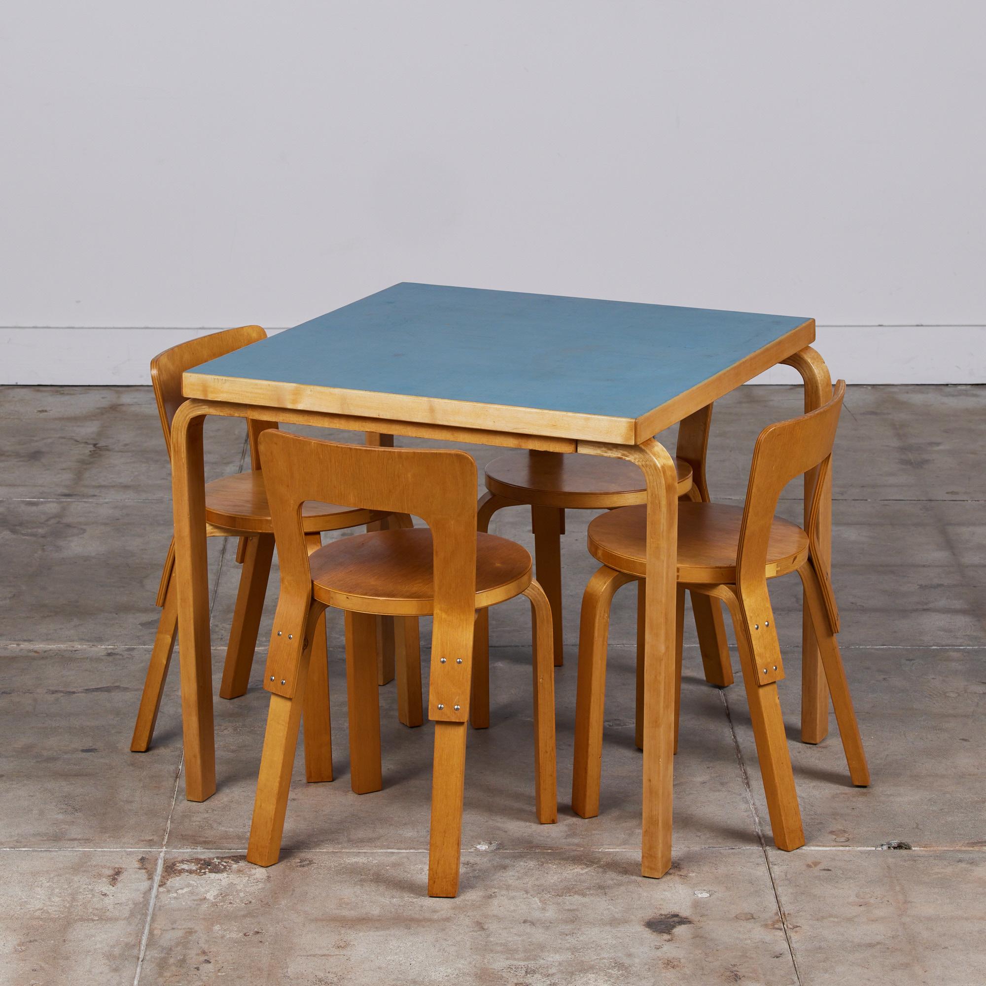 Dining set designed by Alvar Aalto, for Artek. This set features a square birch table with blue laminate top that sits atop bentwood legs and four 