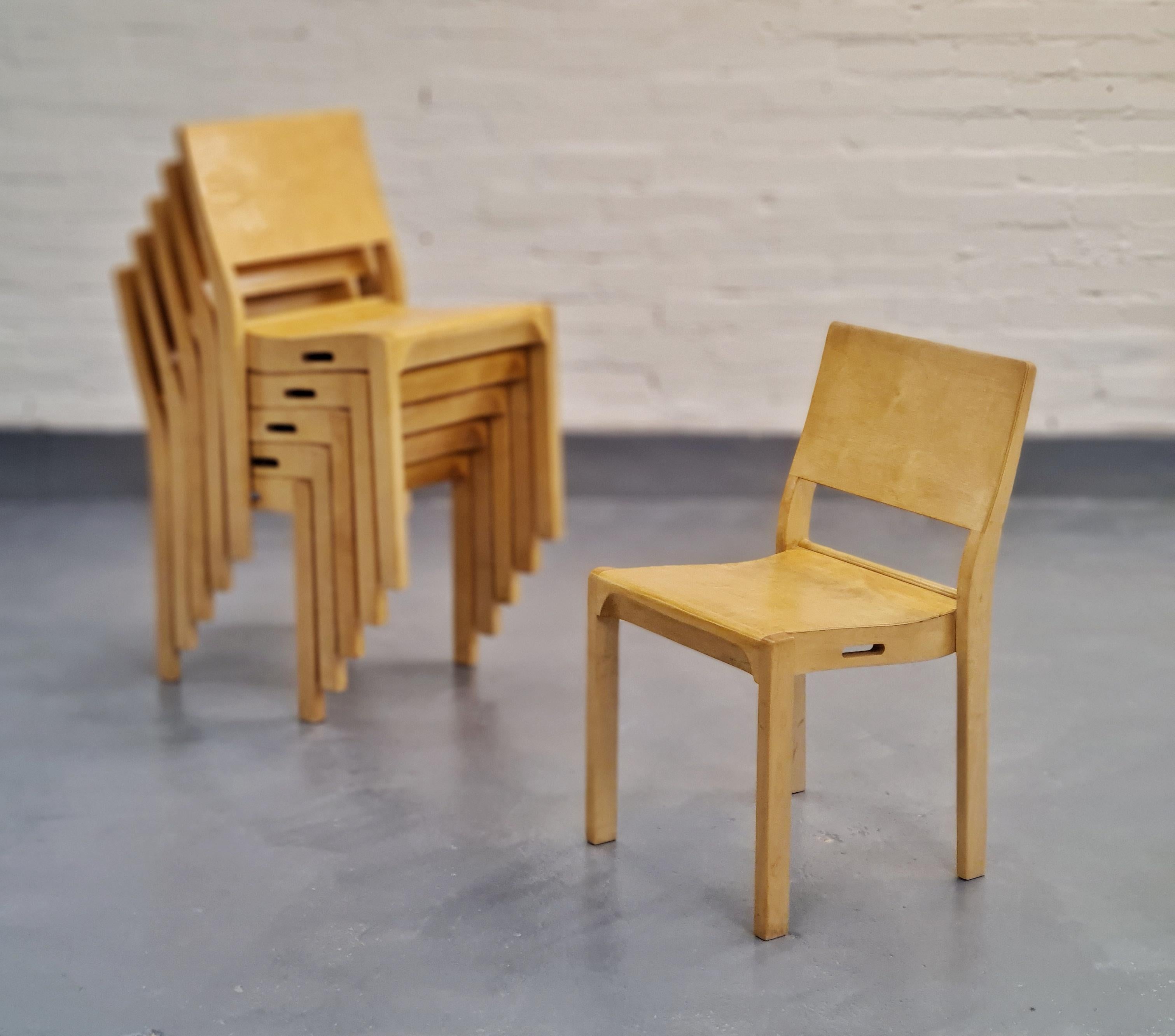 A beautiful minimalistic dining set by Alvar Aalto consisting of a foldable table model DL 82 and six stackable chairs model 611. These items were made by the Huonekalu- Ja Rakennustyötehdas for Artek. 
The award winning chair already designed in