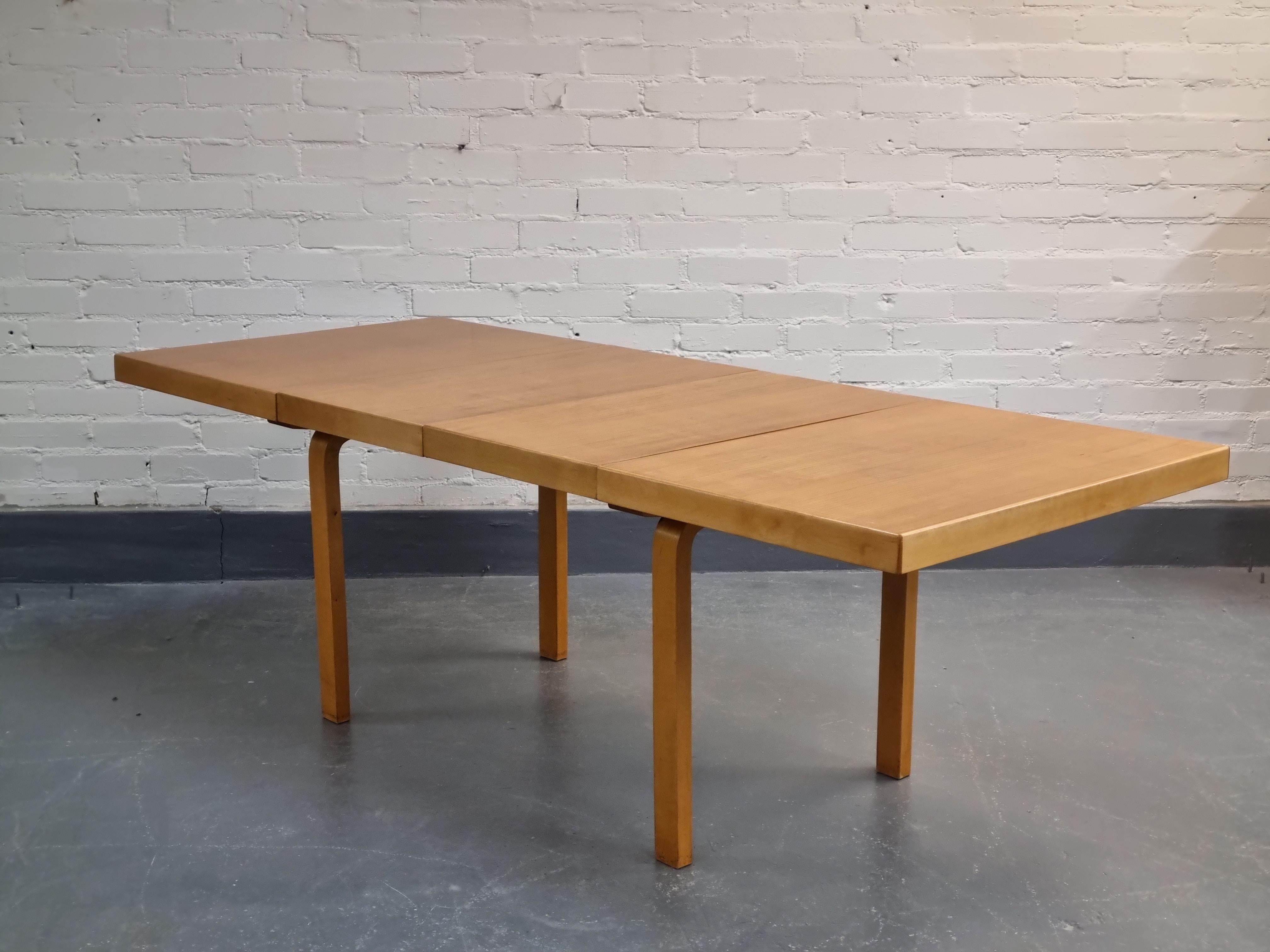 This is a beautiful extending table model 92 by Alvar Aalto from 1940s. Body of the table is solid birch. The surface of the table is laminated by oak veneer. Extension leaf to be stored underneath the tabletop. Total length fully extended with both