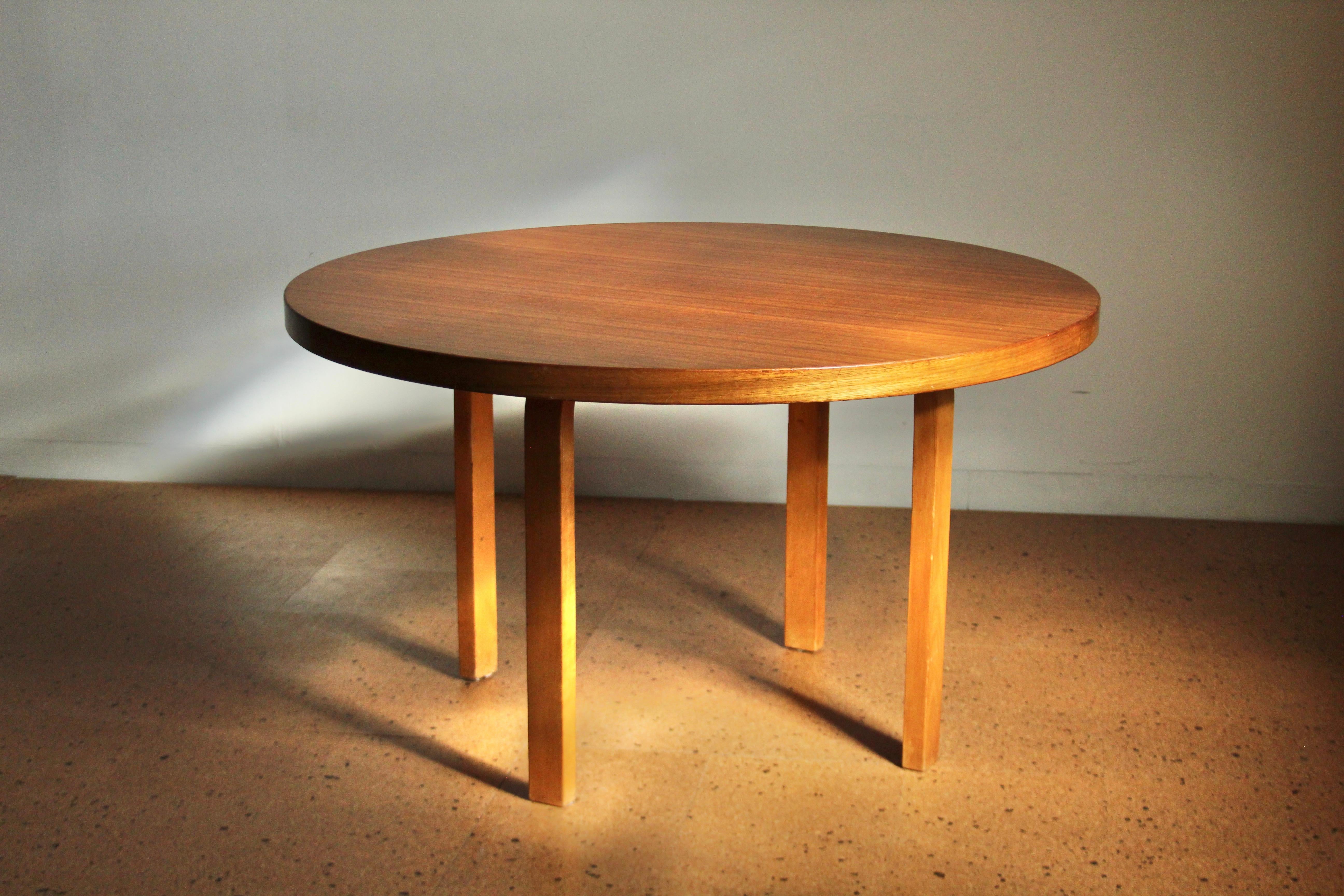 Alvar Aalto early dining table for Finmar, circa 1930s. This unique example features a very rare mahogany veneered top, perched atop Aalto's iconic bent plywood L-legs. We have decided to leave this artifact in its original condition with light