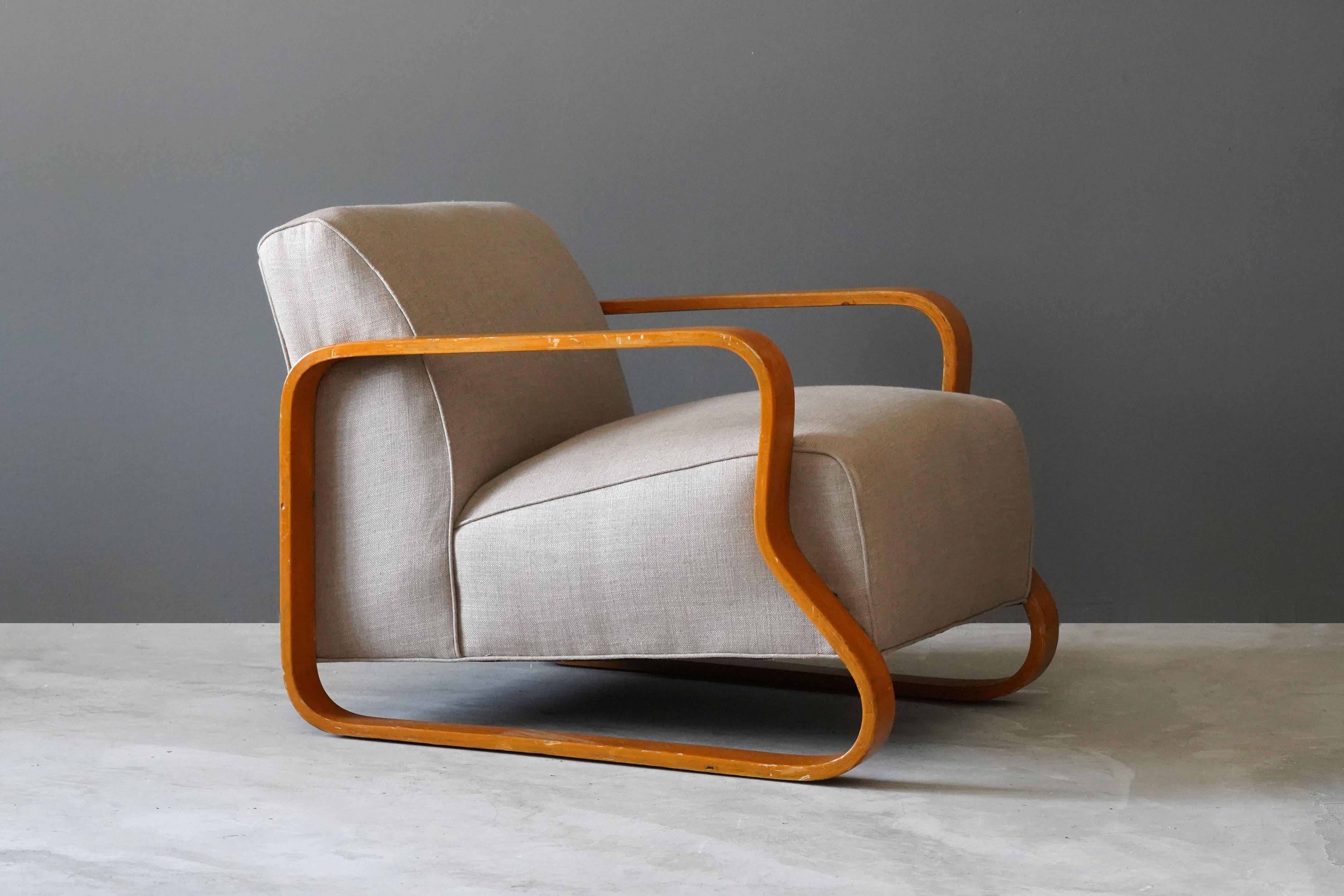 A rare and early lounge chair, designed by Alvar Aalto. Distributed to the UK and internationally by Finmar Ltd. Executed in bent birch, reupholstered in brand new high-end fabric. 

Other designers of the period include Paavo Tynell, Kaare Klint,