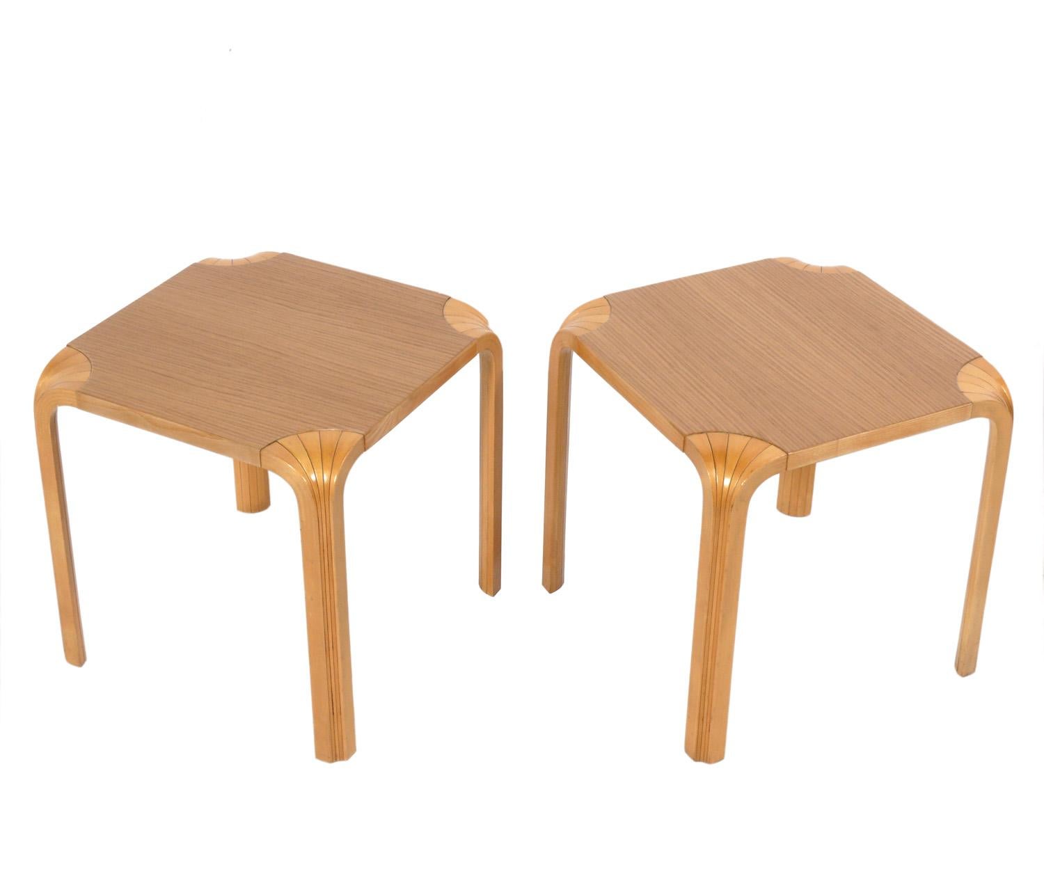 Pair of clean lined fan leg tables, designed by Alvar Aalto for Artek, Finland, circa 1980s. They are a versatile size and can be used as end or side tables, or as nightstands. The price noted below is for the pair of tables.