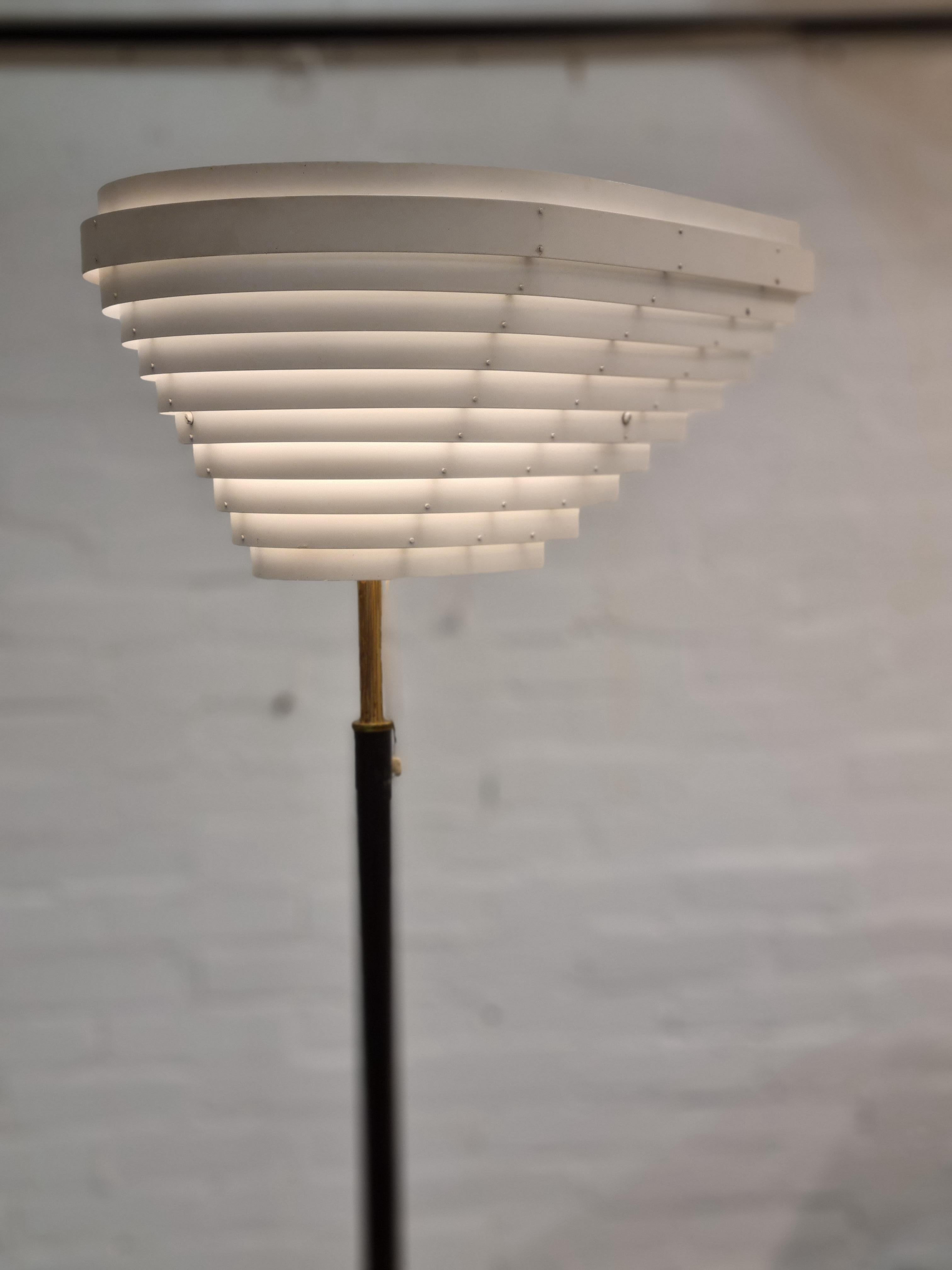 One of the most iconic lamps by Alvar Aalto, this impressive “Angel Wing” lamp was designed by Alvar Aalto in 1954 for the National Pensions Institute in Helsinki. 
The large asymmetrical wingshape shade is formed from painted metal strips. The