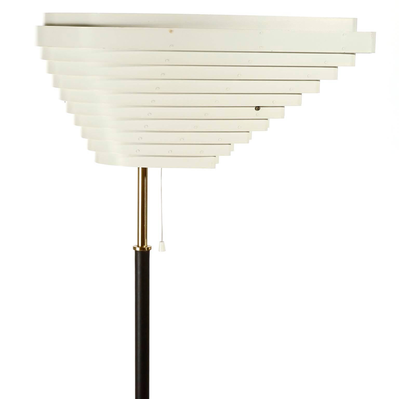 An early floor lamp model A805 'Angel Wing' designed by Alvar Aalto for Valaisinpaja Oy, Finland, manufactured in midcentury, circa 1954. The light originally was designed for the National Pensions Institute in Helsinki. 
Base and stem are wrapped