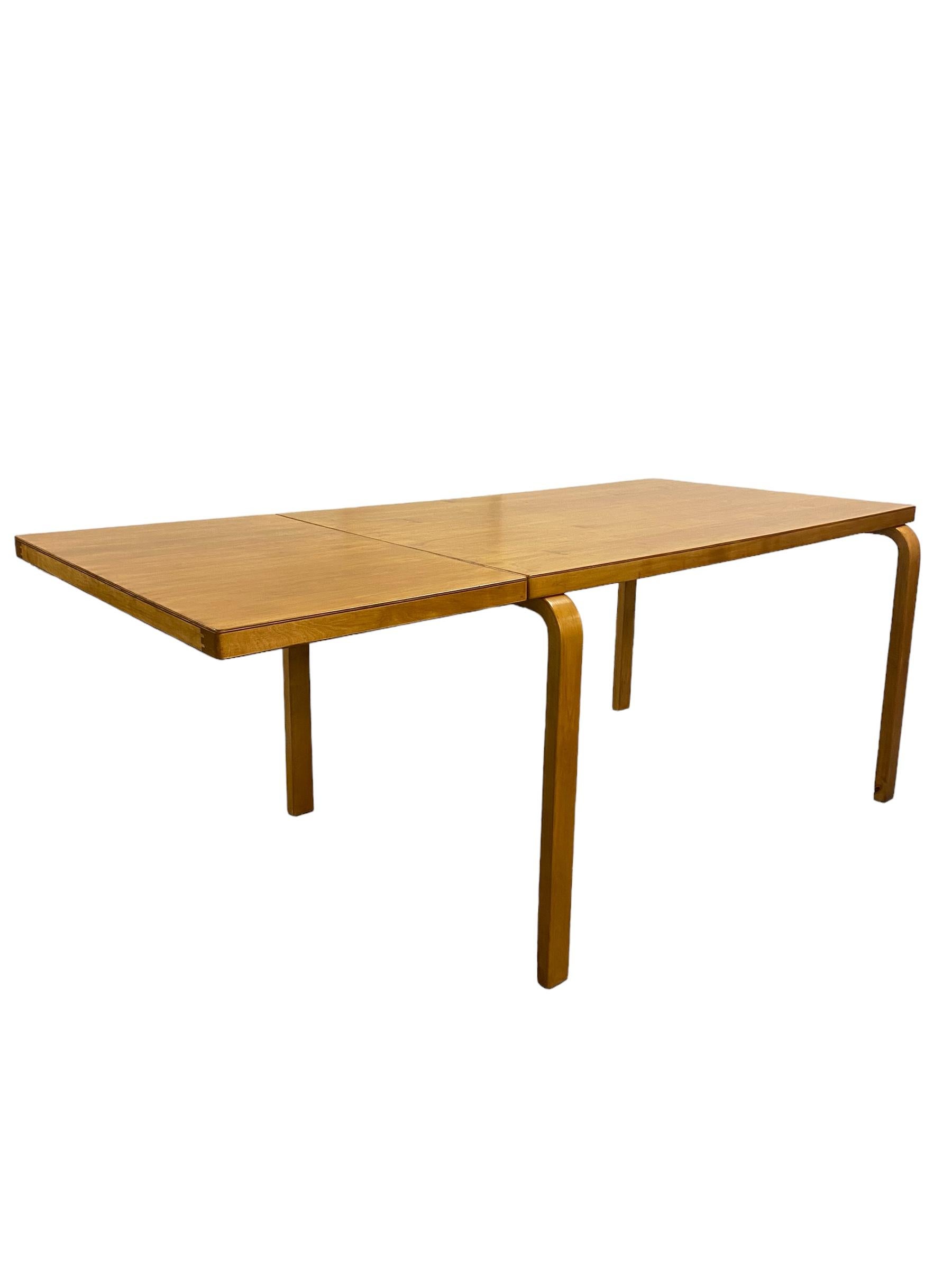 A foldable table in birch with beautiful patina, designed by Alvar Aalto and retailed by Artek in the 1950s. Grown beautiful with age and use for over 70 years, the patina is exactly what makes this piece so unique. The table has a foldable