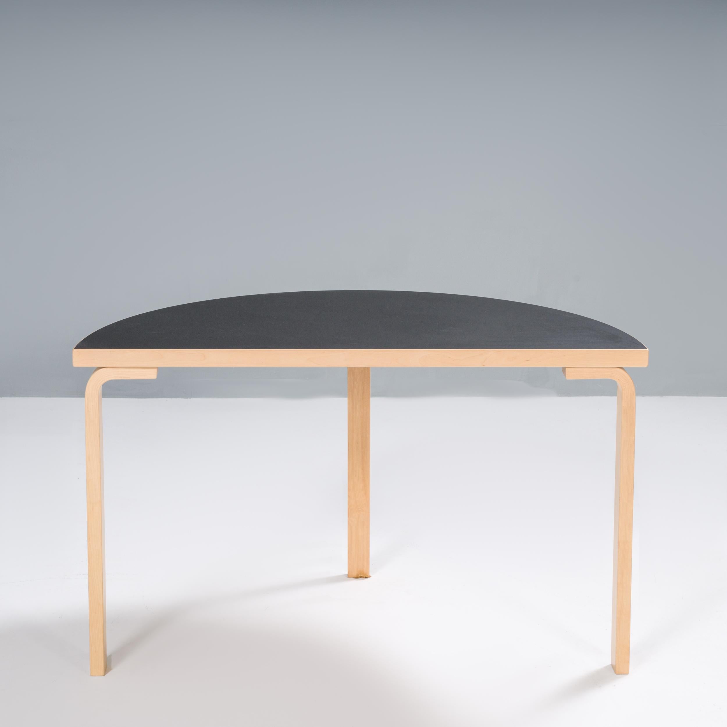 Originally designed by Alvar Aalto in 1933, this half-round table formed part of his iconic L-leg collection.

Aalto created the collection after experimenting with bending wood in the early 1920s, before patenting his technique in 1933.

The
