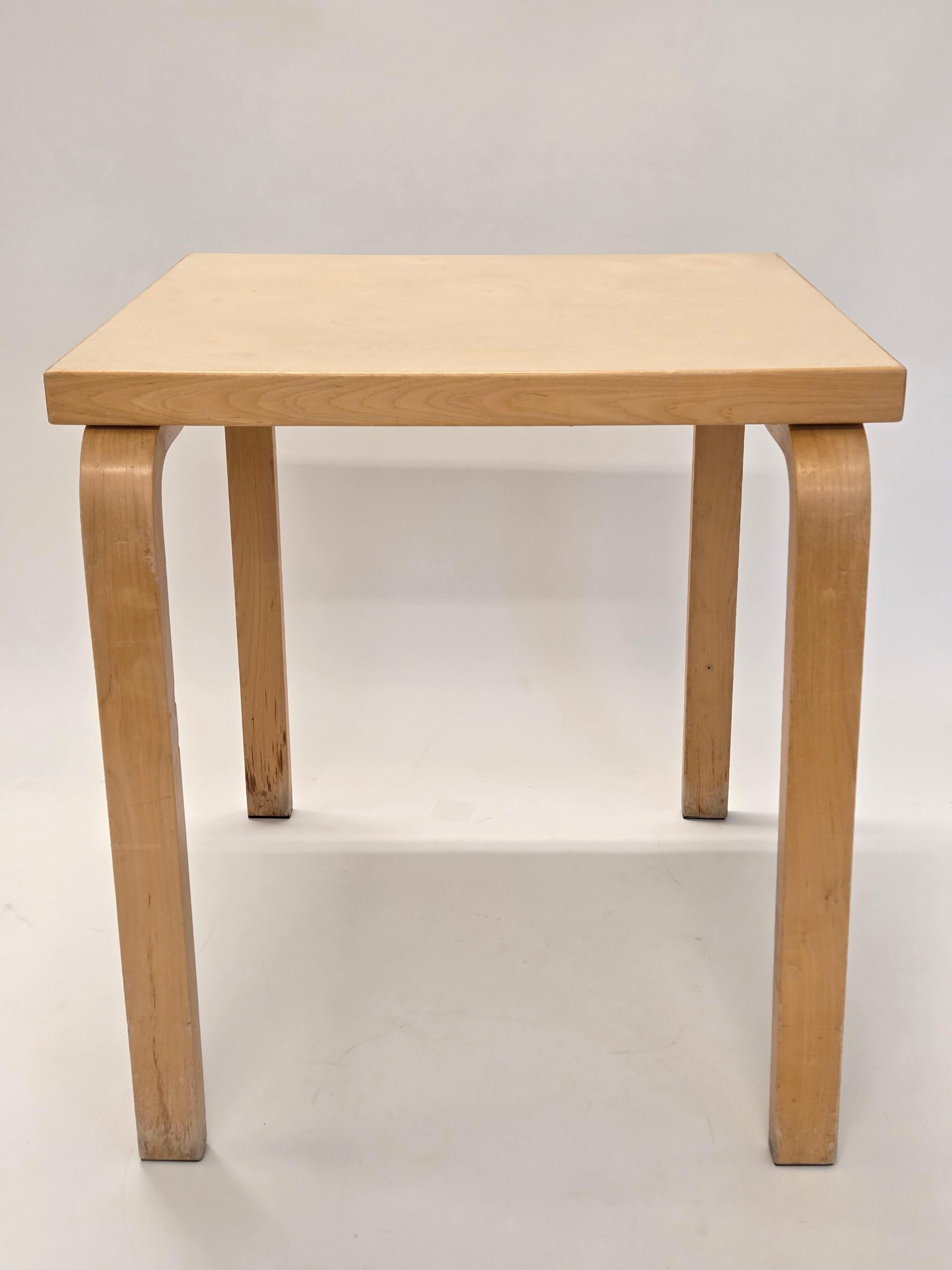 Artek table, birch with cream linoleum. Designer Alvar Aalto. The table is from around the 1960s. A few extra holes in the table legs. Wear consistent with age. Great patina. 

Size of the table top is 61 cm x 61 cm, and height of the table 65,5 cm.