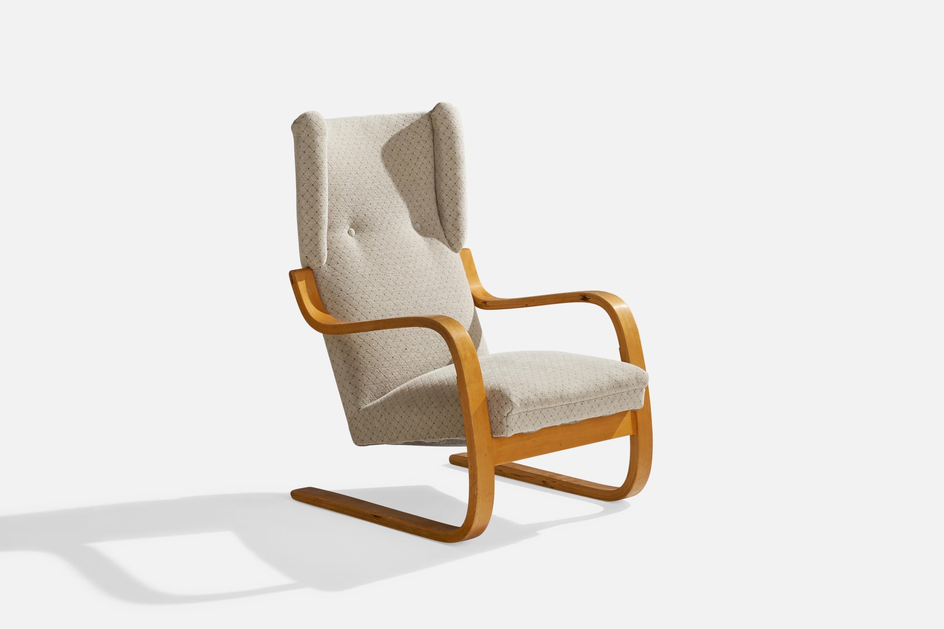 A moulded birch and light-grey fabric lounge chair desisgned by Alvar Aalto and produced by Artek, Finland, c. 1970s.

seat height 15”. 