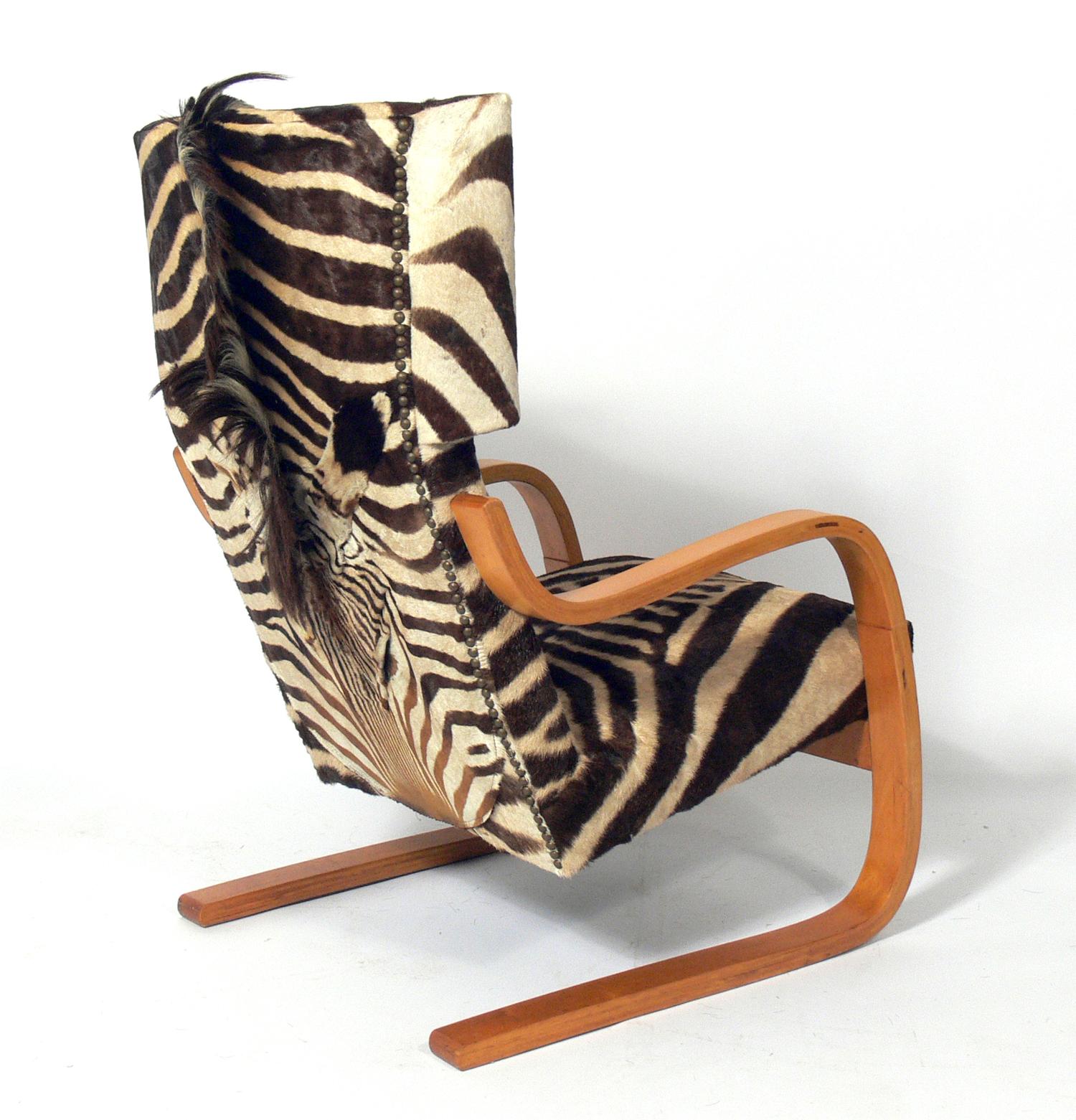 Tall back cantilevered lounge chair in zebra hide, designed by Alvar Aalto for Artek, Finland, originally designed circa 1930s, this example is circa 1950s.