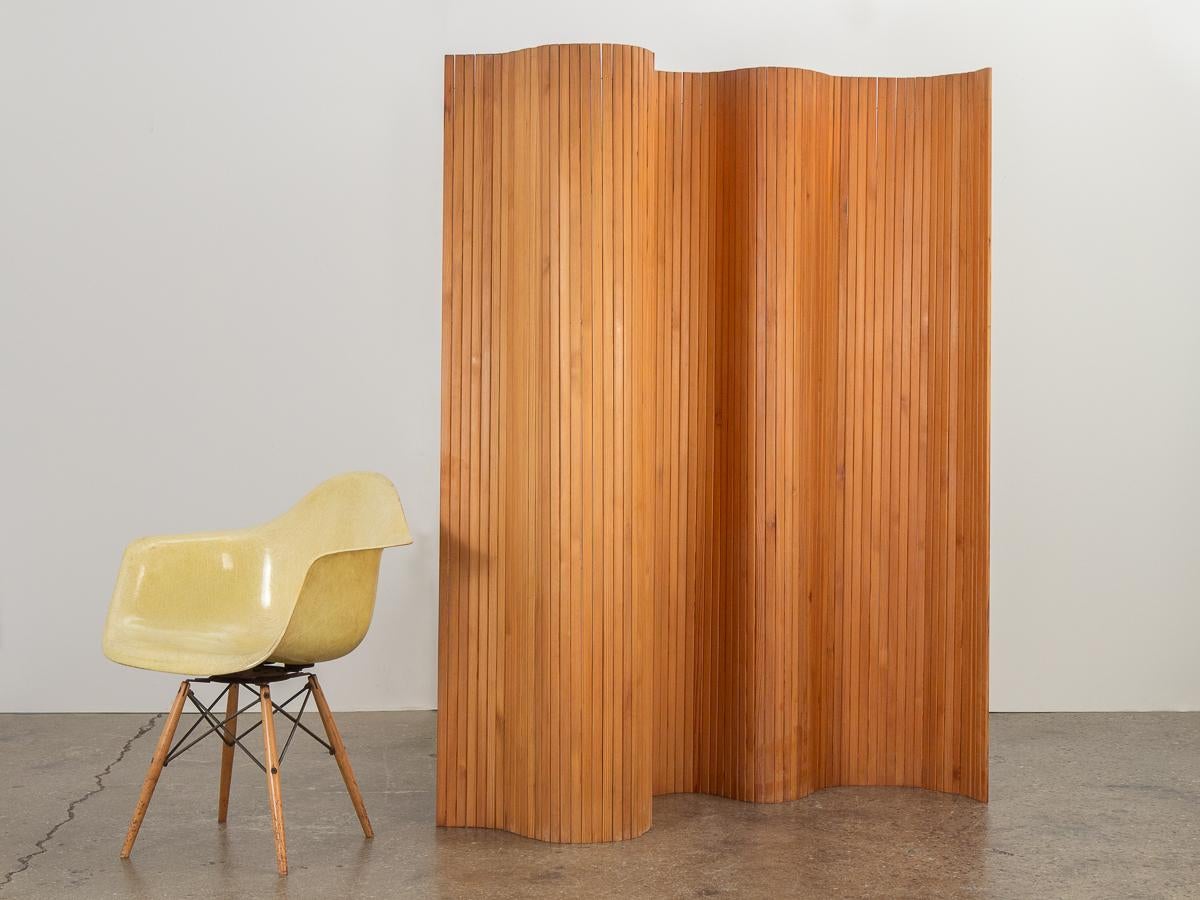 Vintage Model 100 Pine Screen designed by Alvar Aalto for Artek. Made of fine pine wood slats joined by invisible metal wire, the screen's ingenious design allows it to be formed into a variety of appealing shapes. The flexible screen rolls up when