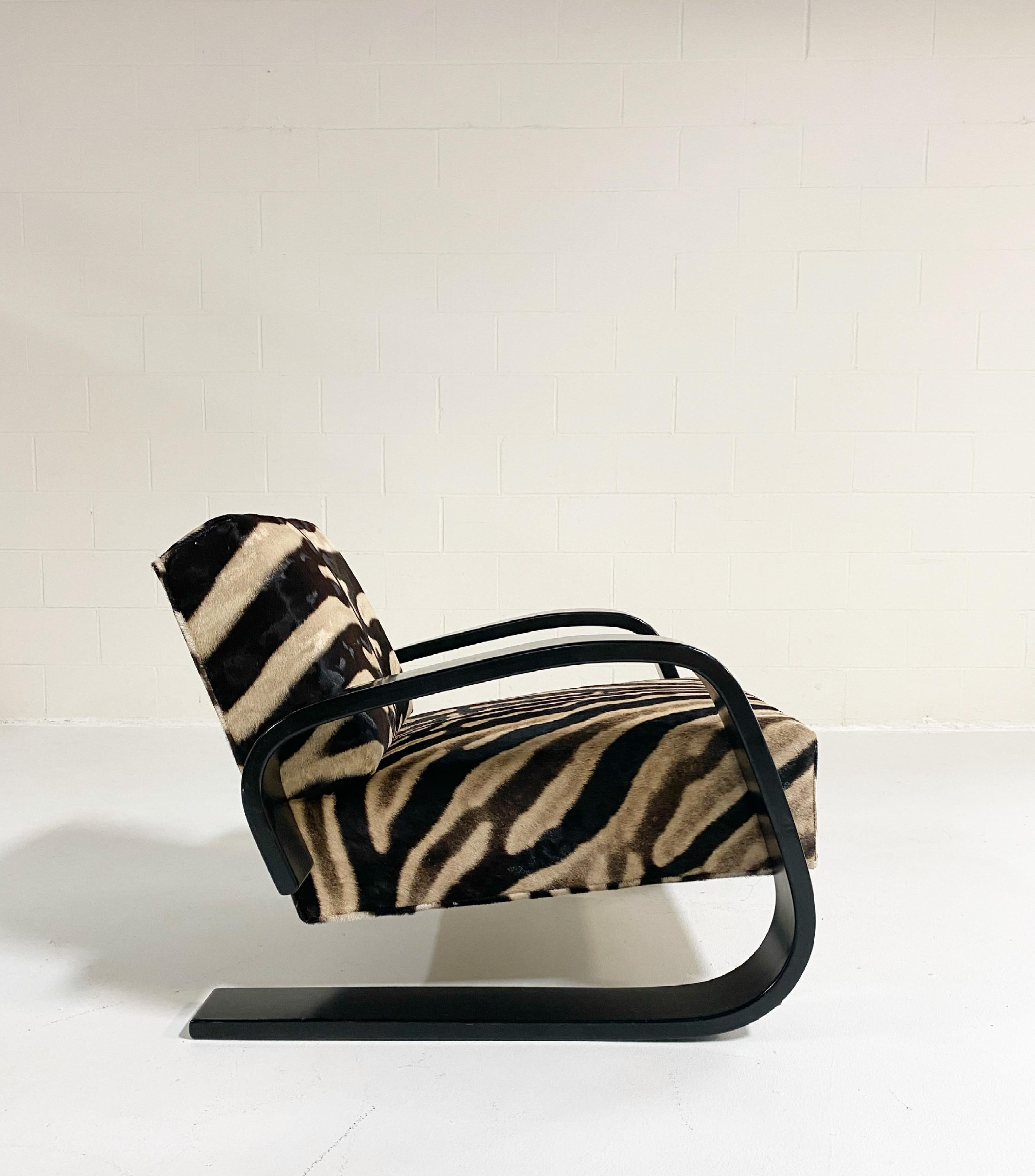 A beautiful Tank armchair, masterfully restored in zebra hide. The armchair 400 or 