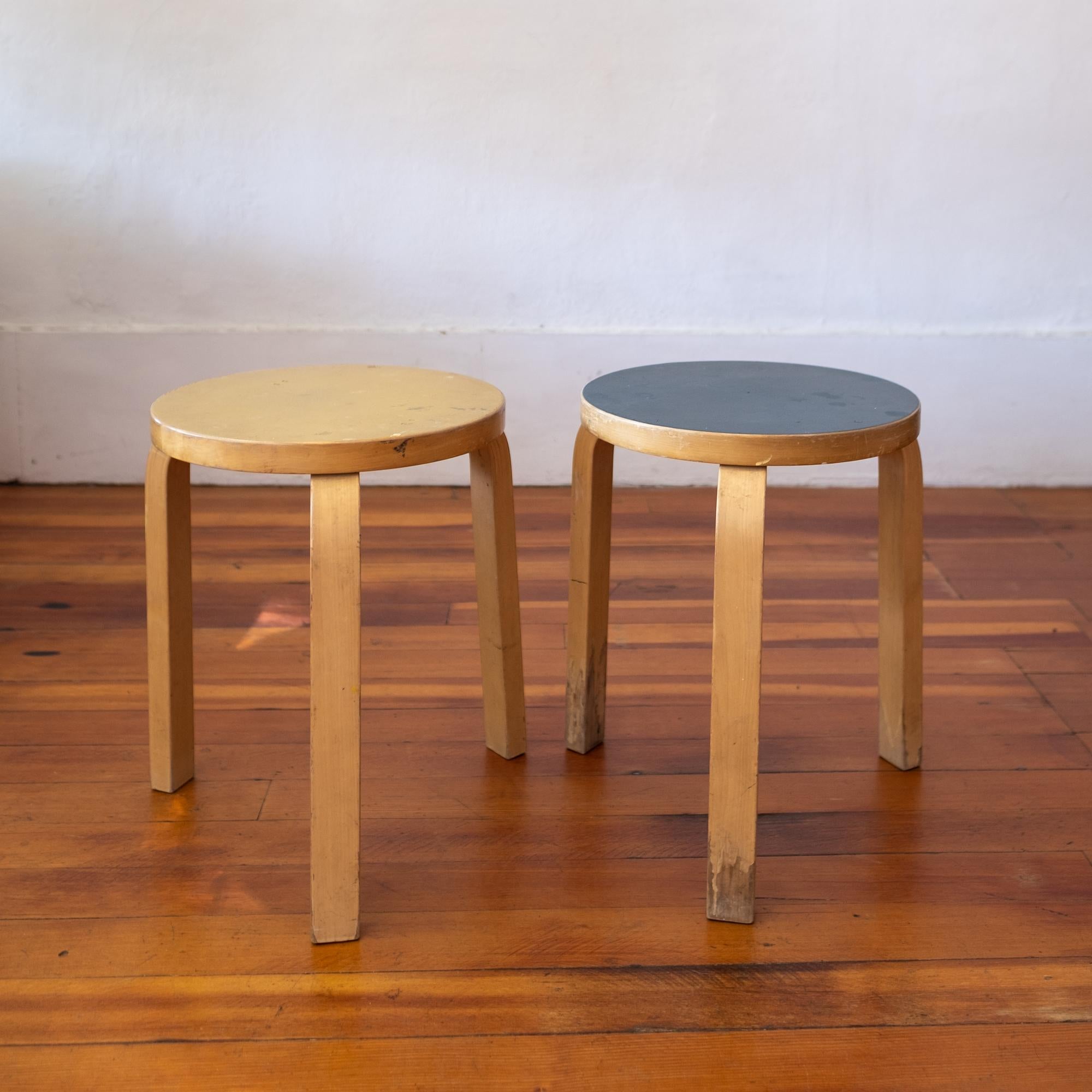 A pair of vintage Alvar Aalto model 60 linoleum top stools. Nicely warn yellow and blue top stools. Birch bentwood legs with Aalto’s signature feathered bentwood leg design. Great patina, 1950s.