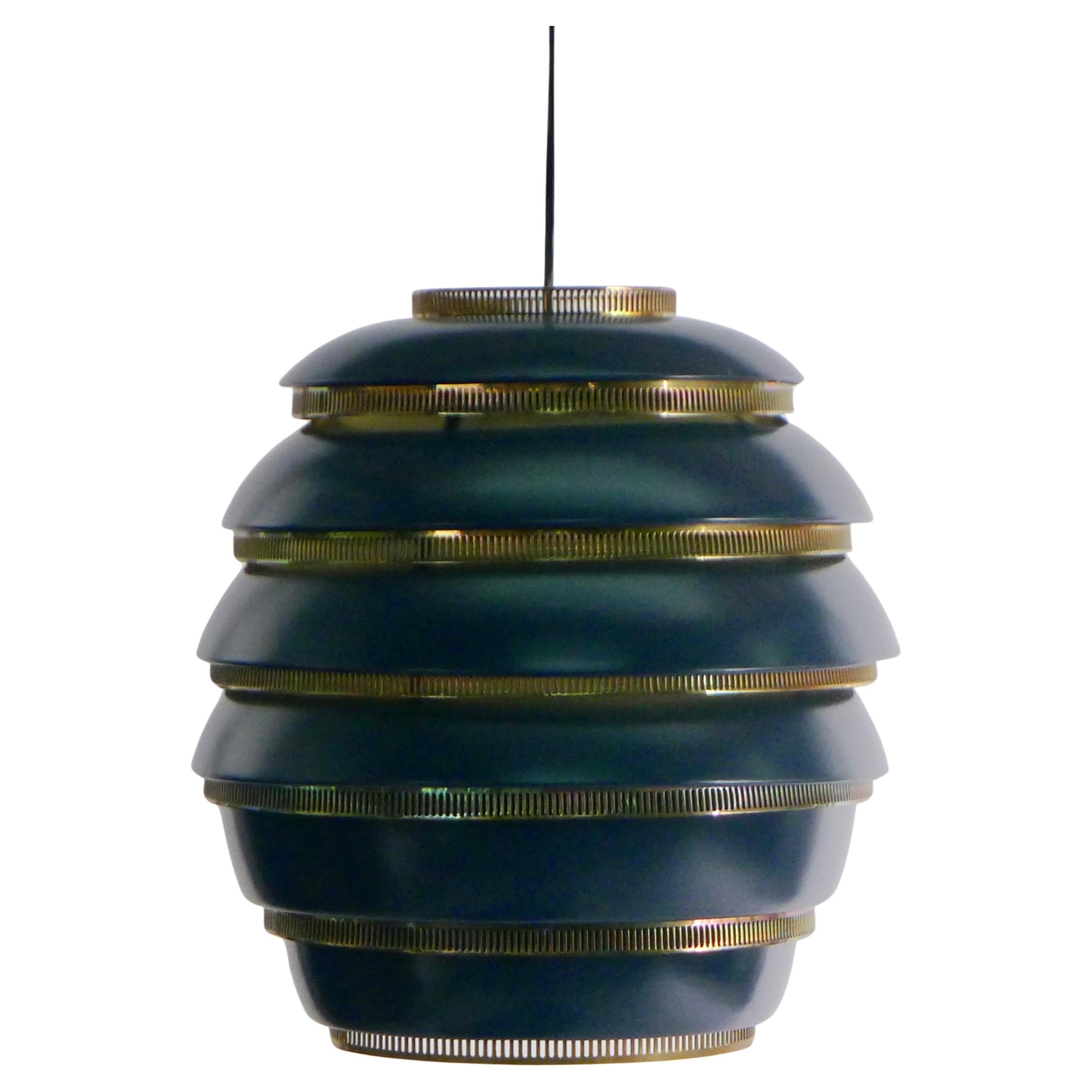Alvar Aalto (Finnish 1898-1976)
Beehive Pendant Light, model A332
constructed from six dark blue enamelled aluminium bands with pierced polished brass mounts to diffuse the light
stamped with manufacturer's name and model number
35cm high, 33cm