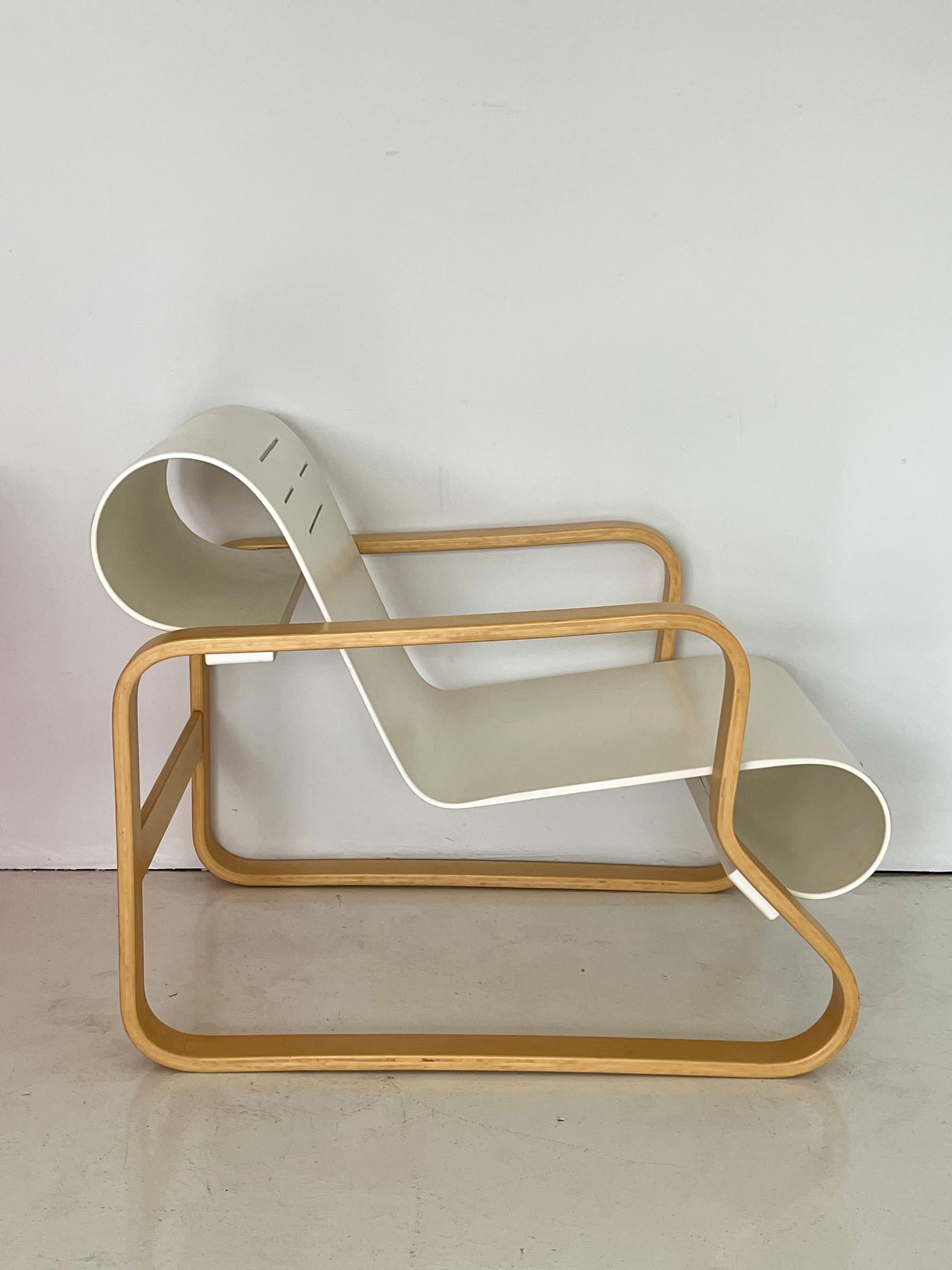 Paimio Chair in bentwood frame with white laminate seat. Iconic design by Alvar Aalto in 1929 this version was produced by Artek in 2002 and retains its original label. Good condition with minor surface wear.